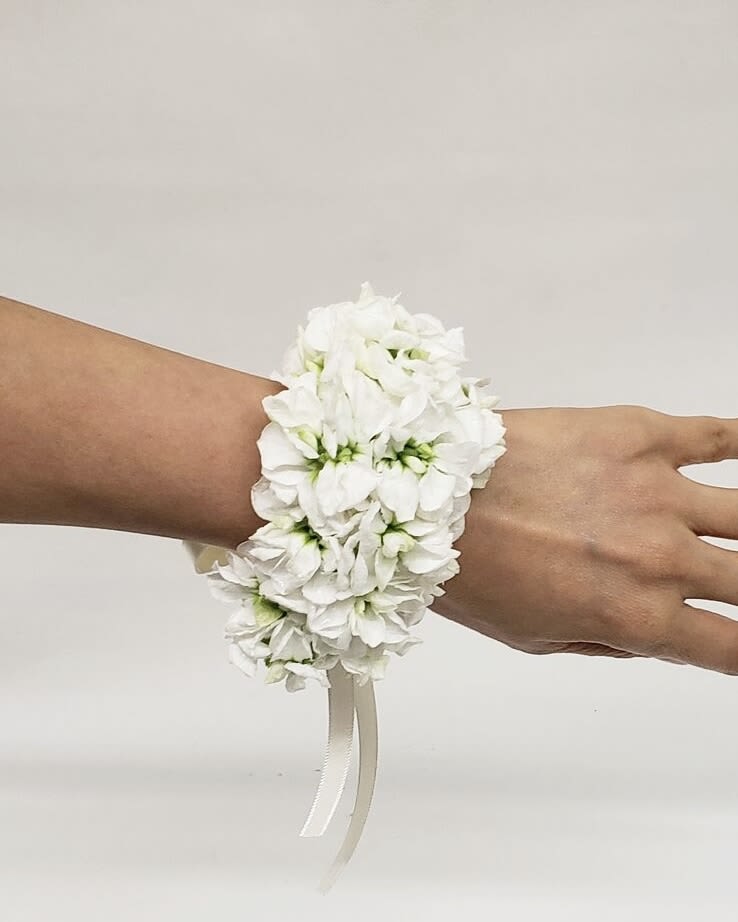 White floral wrist corsage with ribbon ties