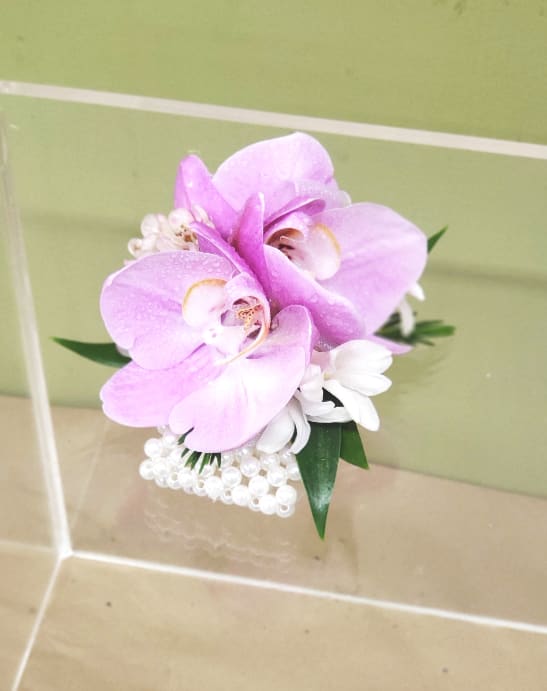 Pink orchid corsage with white accents and pearl trim