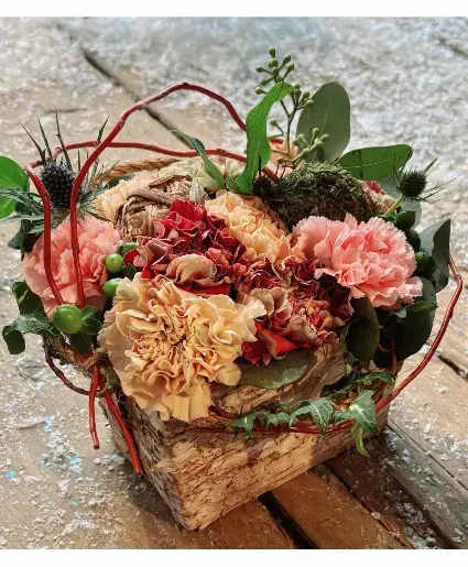 Antique Carnation Arrangement - Antique carnations in peach, maroon, mauve and dusty pink carnations with some nature-inspired elements in this birch bark vase arrangement.  Includes: Carnations, Berries, Moss, Foliage, Ivy, Birch Bark Vase.