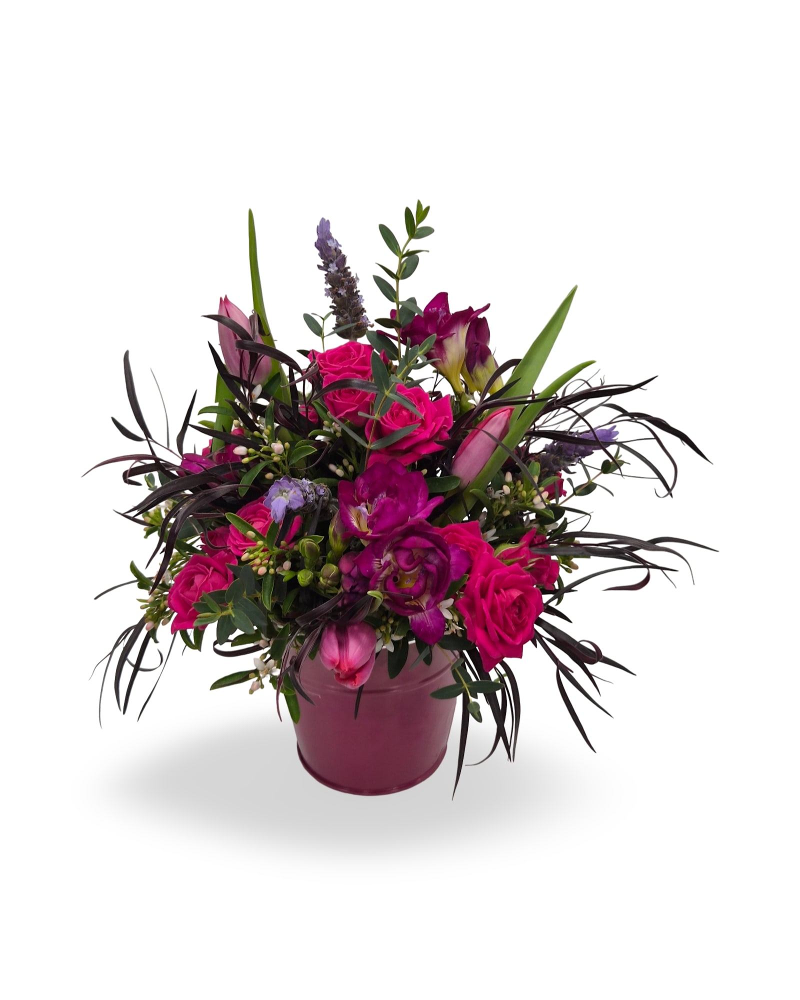 Vibrant arrangement of hot pink roses and purple flowers in a pink ceramic pot