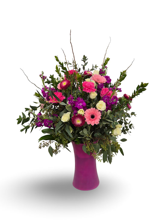 Pink and purple mixed bouquet in a magenta vase