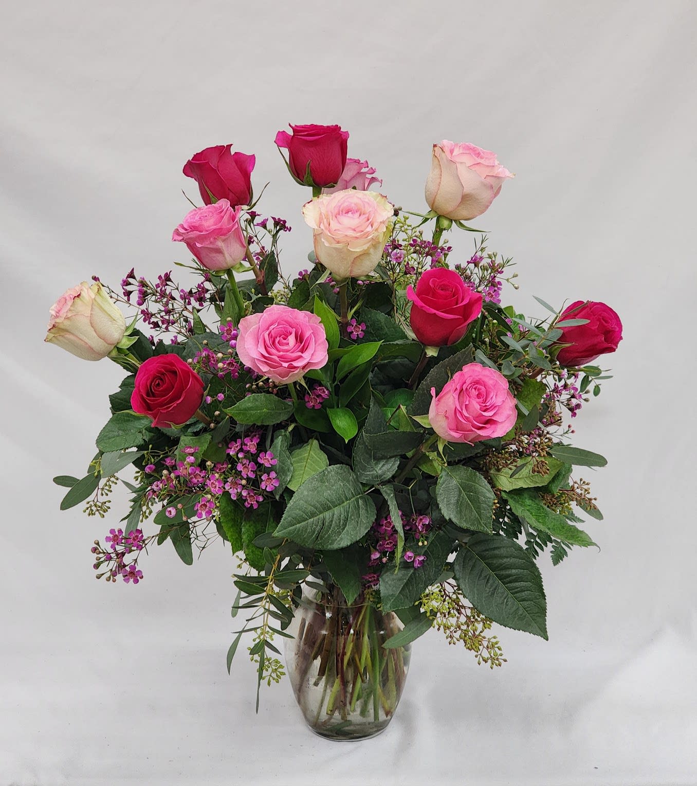 Medium Stem Dozen Mixed Pink Roses - Select this arrangement of one dozen, mixed Valentine's Day colored medium stem roses. Filler flower will vary.