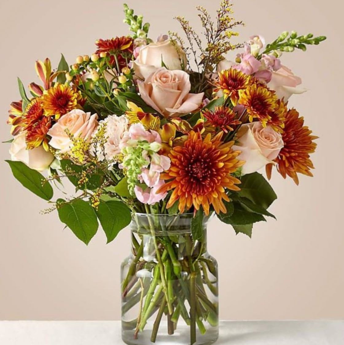 Rosy Dunes - Rosy Dunes is a warm, romantic arrangement inspired by soft rosy tones and sun-kissed hues. Layers of pink blooms mingle with rich terracotta, muted peach, and sandy neutrals, creating a palette that feels earthy, glowing, and full of depth. Airy textures and natural movement give the design an effortless garden style, with petals and foliage flowing together in a soft, graceful blend. Rosy Dunes brings warmth, richness, and a gentle glow to any space.