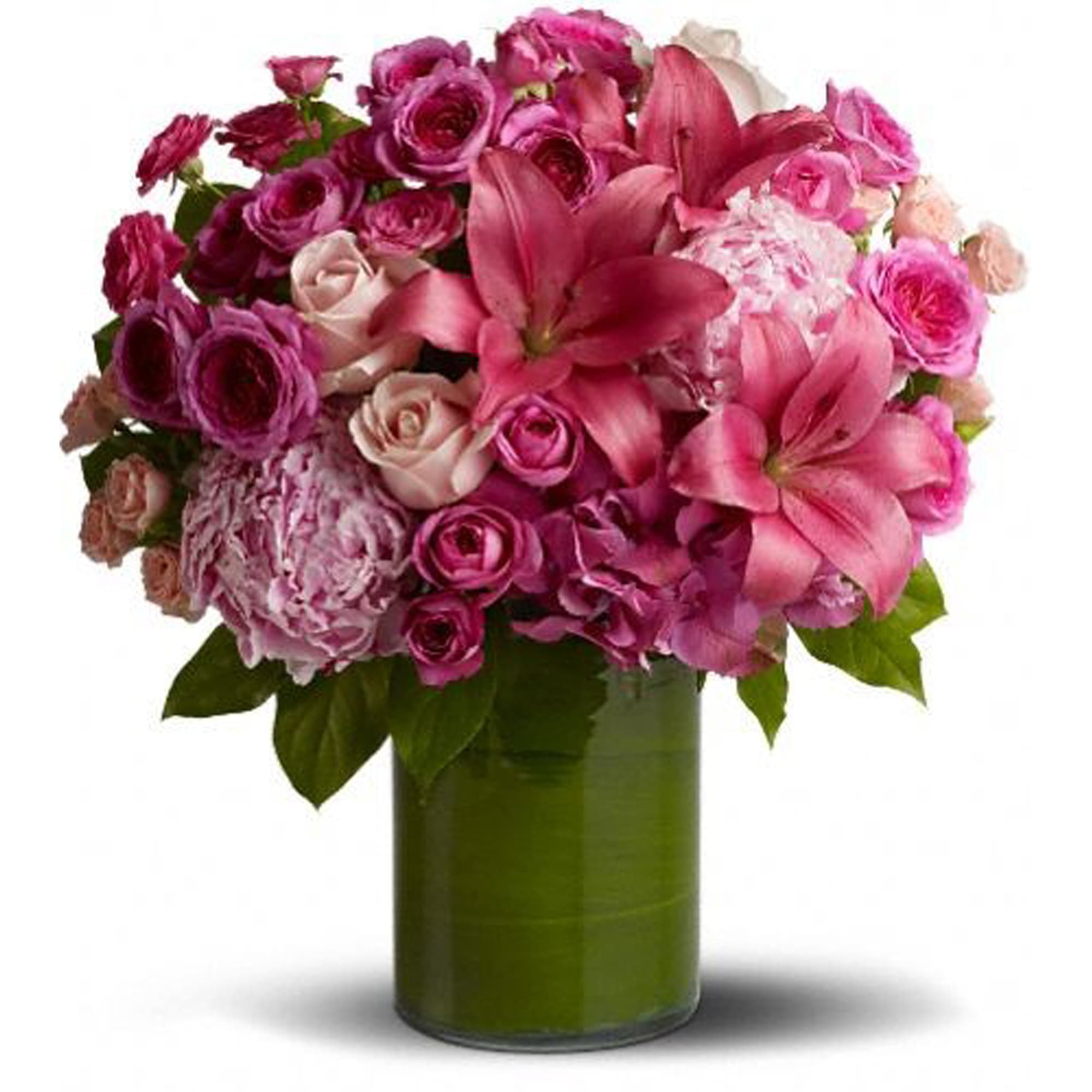Pink and purple flower bouquet in a green glass vase