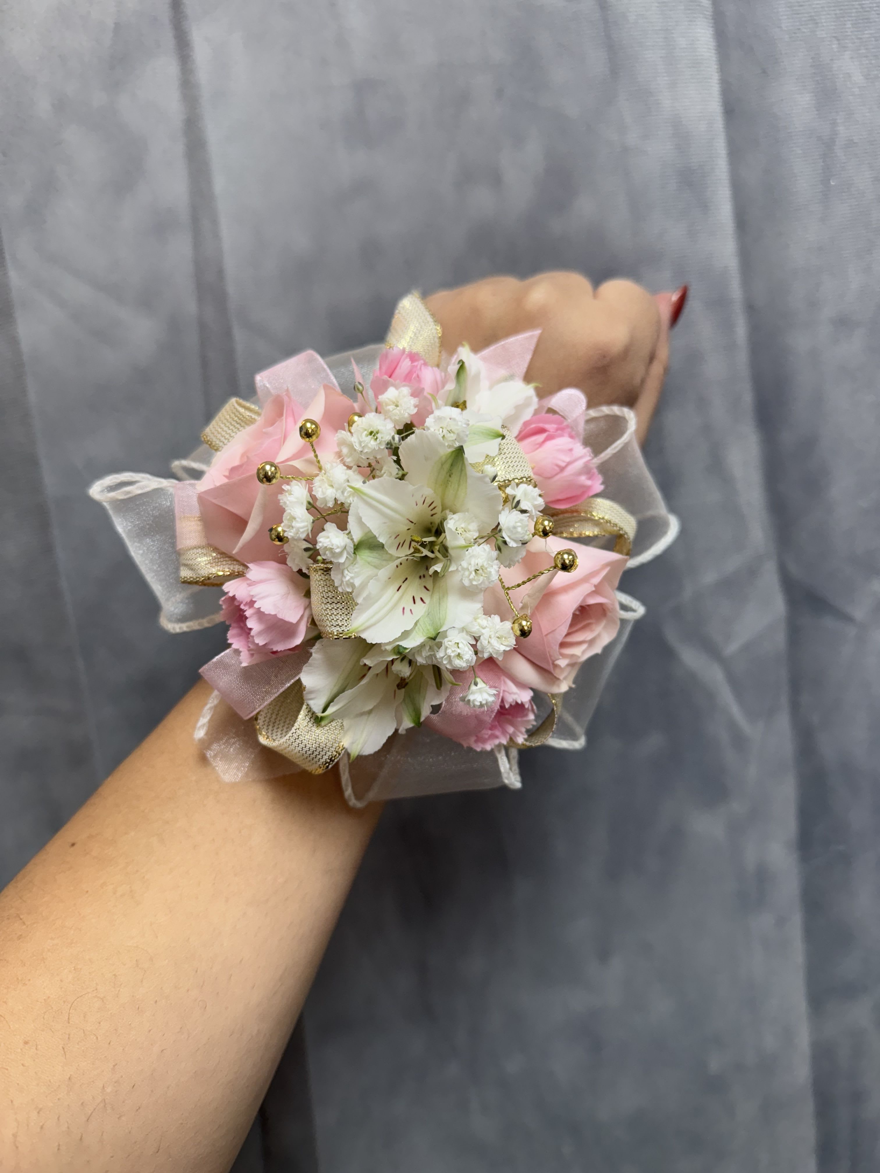White pink alstroemerias spray rose corsage - White pink gold corsage , made with white alstroemeria, pink spray roses and mini carnation. The corsage has gold accents and made with pearl bracelet .  The corsage can be customized upon request  
