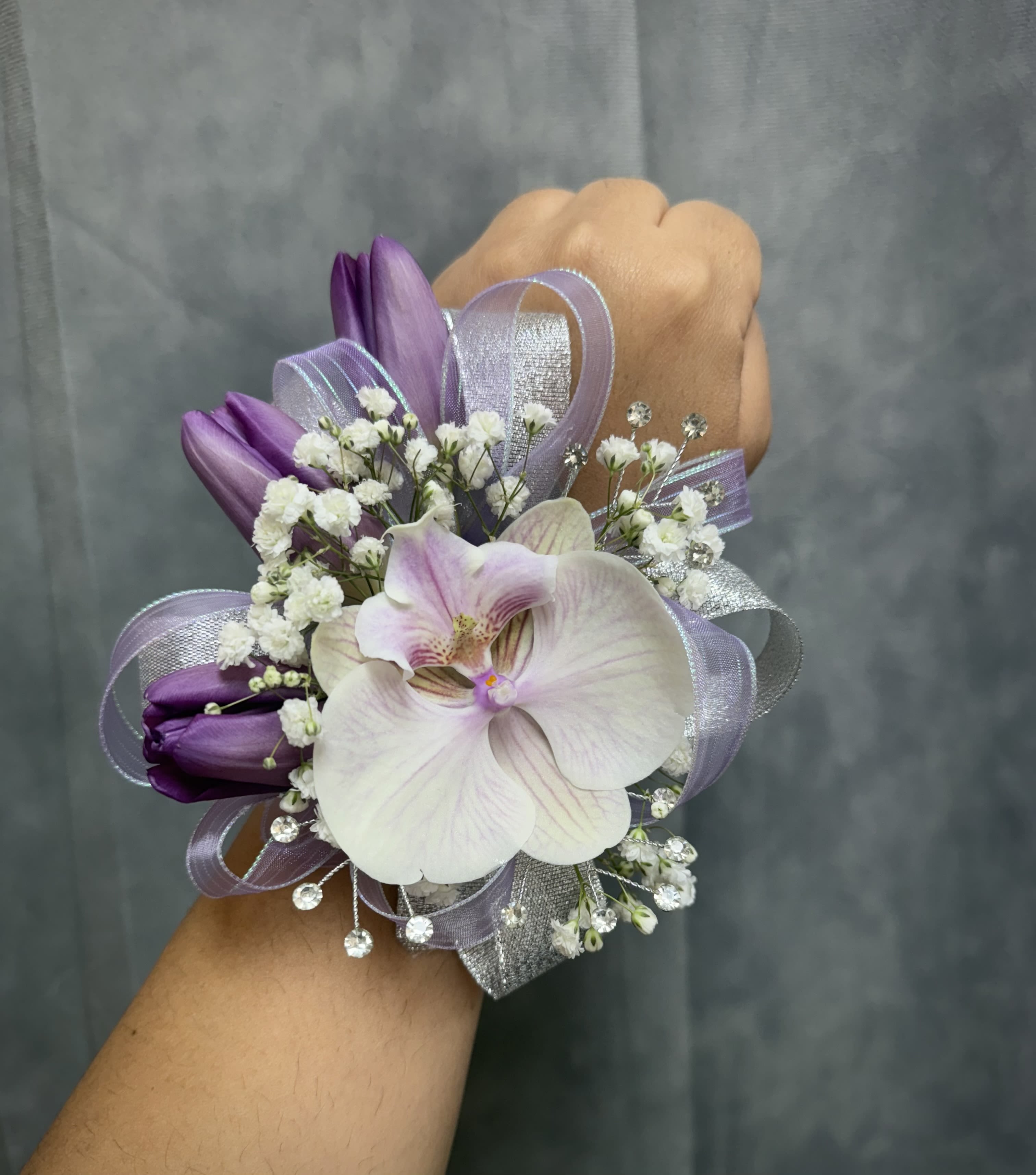Purple tulips orchid corsage - Orchid wrist corsage with deep purple tulips , white fillers and lavender loops, finished with silver ribbon and rhinestone , pearl band elegance for proms .  The corsage can be customized upon request 