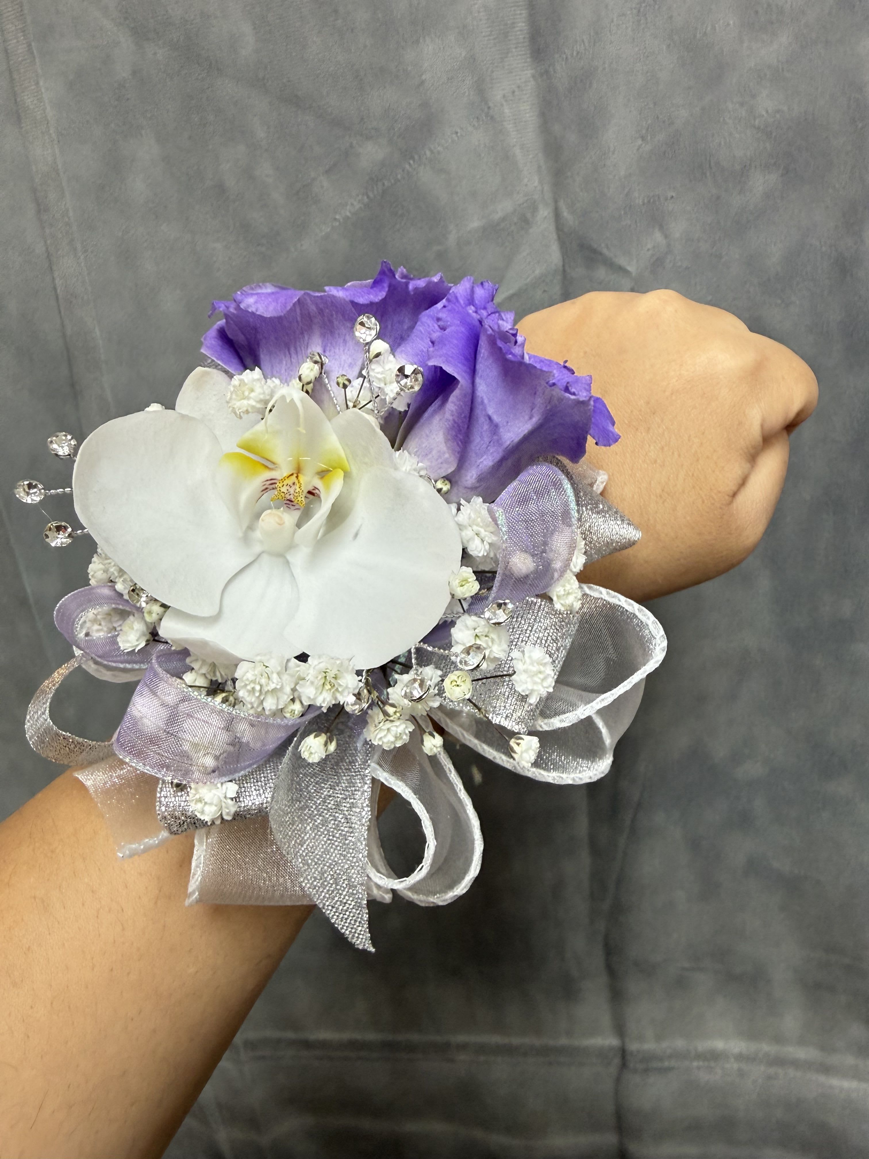 Purple Lisianthus orchid wrist corsage - White Orchid and purple lisianthus-style  with delicate white fillers, silver-lavender ribbon and rhinestone accents on a pearl wrist band - elegant for prom. The corsage can be customized upon request 