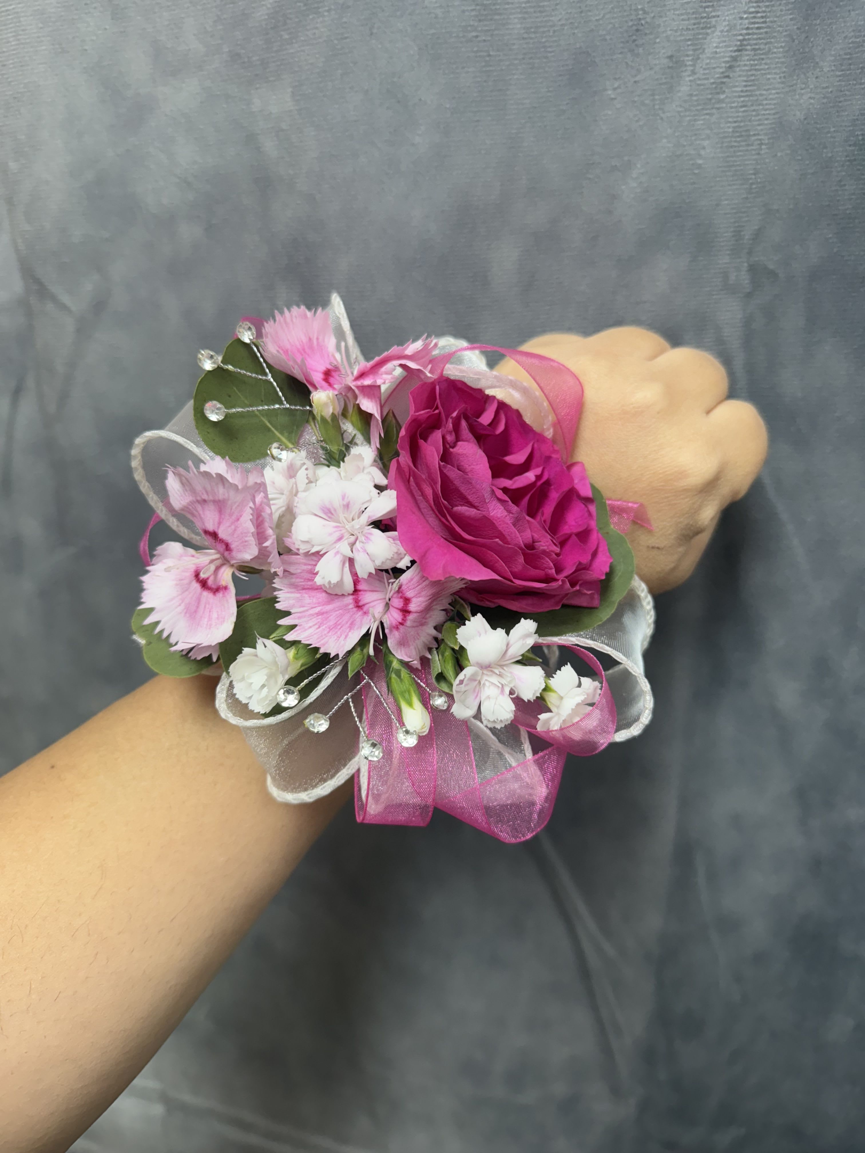 Hot pink spray roses corsage - Hot pink roses with white and pink mini carnation, sheer ribbon and rhinestone picks on a pearl wrist band-feminine, festive corsage for prom.  The corsage can be customized upon request 