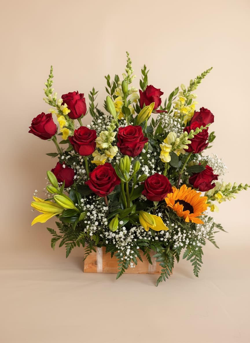 Rustic Bloom Box - A bold and captivating arrangement set in a charming wooden rectangular box, Rustic Bloom Box brings together passionate red roses, elegant lilies, and vibrant sunflowers. 
