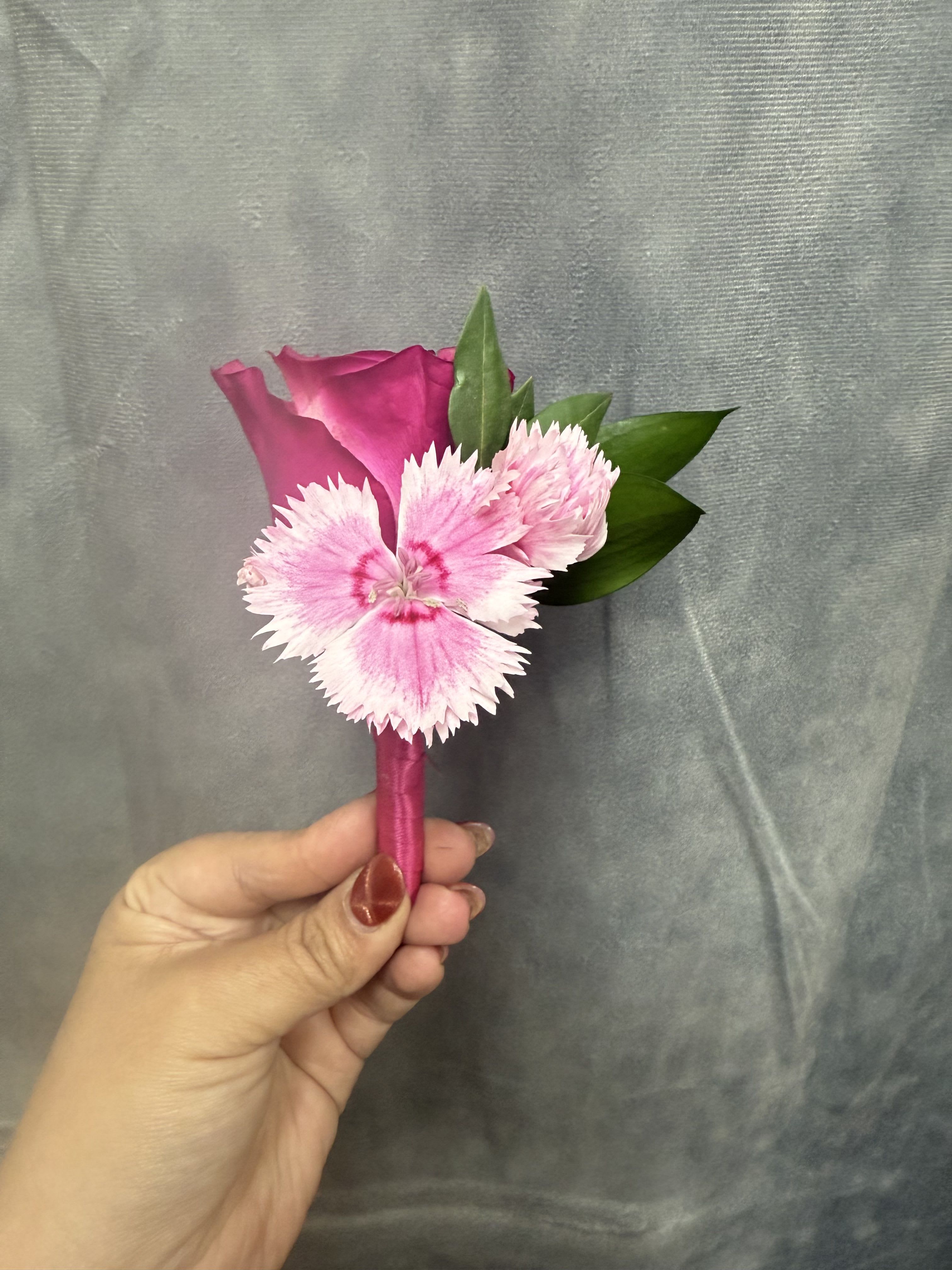 Hot pink rose boutonnière  - Bright hot-pink rose paired with  pink carnation, green accents beautifully wrapped boutonnière.