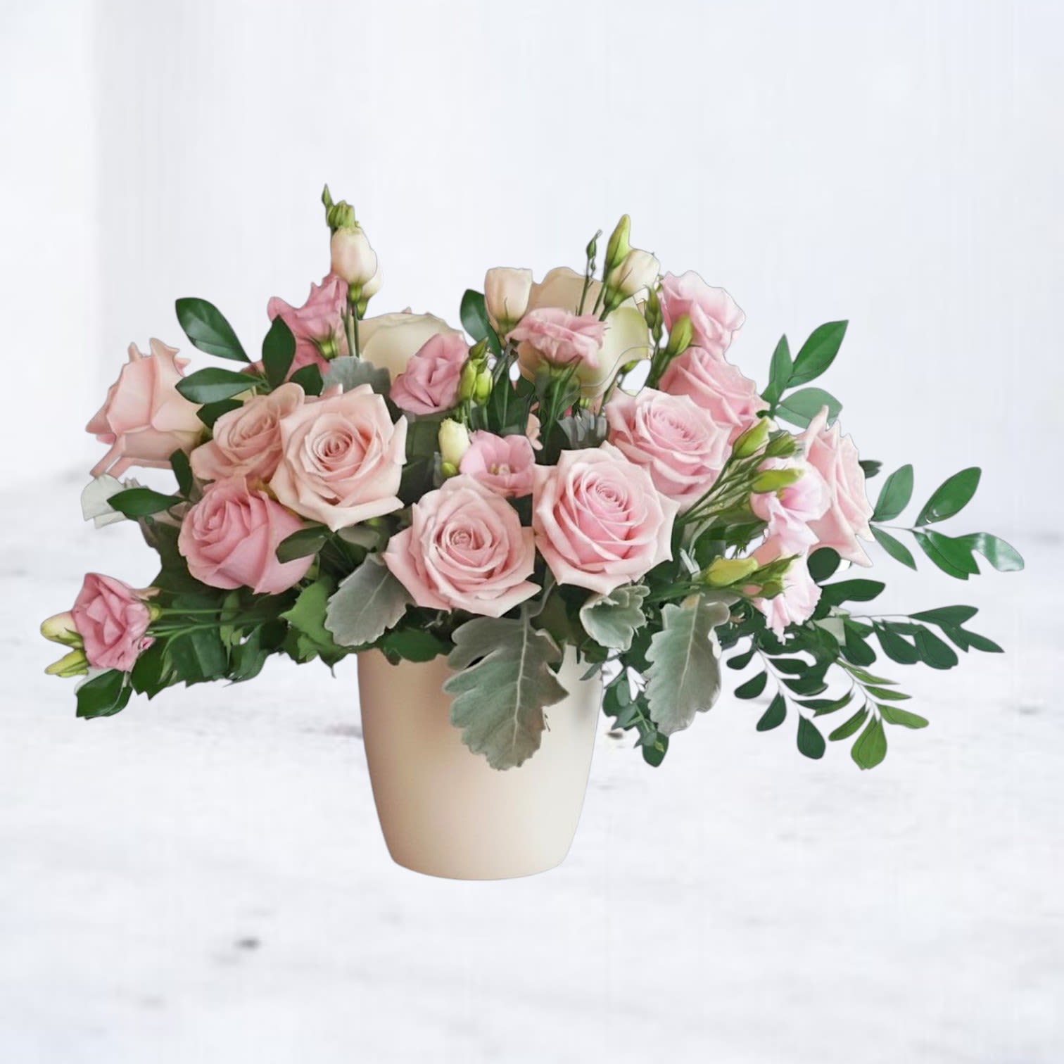 Elowen - Elowen is a soft, refined floral arrangement designed with delicate color, natural movement, and a modern garden-inspired style. Featuring pink roses, soft lisianthus, and fresh seasonal greenery, this arrangement is thoughtfully composed to create a light, airy, and effortlessly elegant look.  Designed in a neutral ceramic vessel, Elowen blends soft blush tones with creamy undertones and fresh greens for a palette that feels calming, romantic, and elevated. The combination of classic roses and delicate accent blooms creates a balanced composition that is both timeless and contemporary.  Perfect for birthdays, anniversaries, sympathy gestures, or sending something soft and beautiful “just because,” this blush pink flower arrangement offers a versatile, universally loved style for any occasion.  Same-day flower delivery is available in Magnolia, TX, The Woodlands, Montgomery, Conroe, Spring, Tomball, and surrounding North Houston areas.  Due to seasonal availability, some blooms may be replaced with similar varieties of equal or greater value to maintain the design’s look and integrity. Your arrangement will always reflect the same color palette, style, and premium quality.