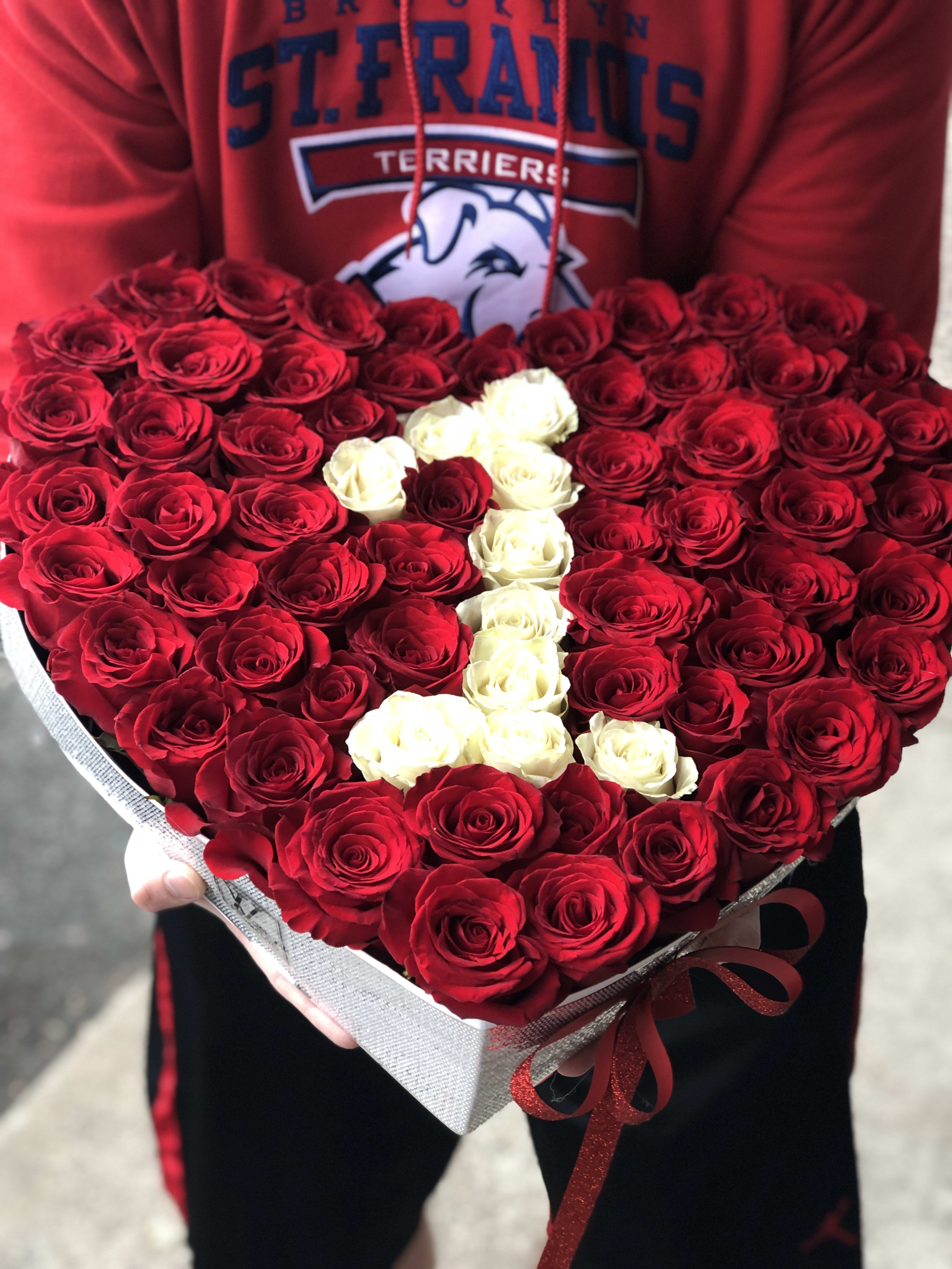 Heart-shaped bouquet of red and white roses in a gift box