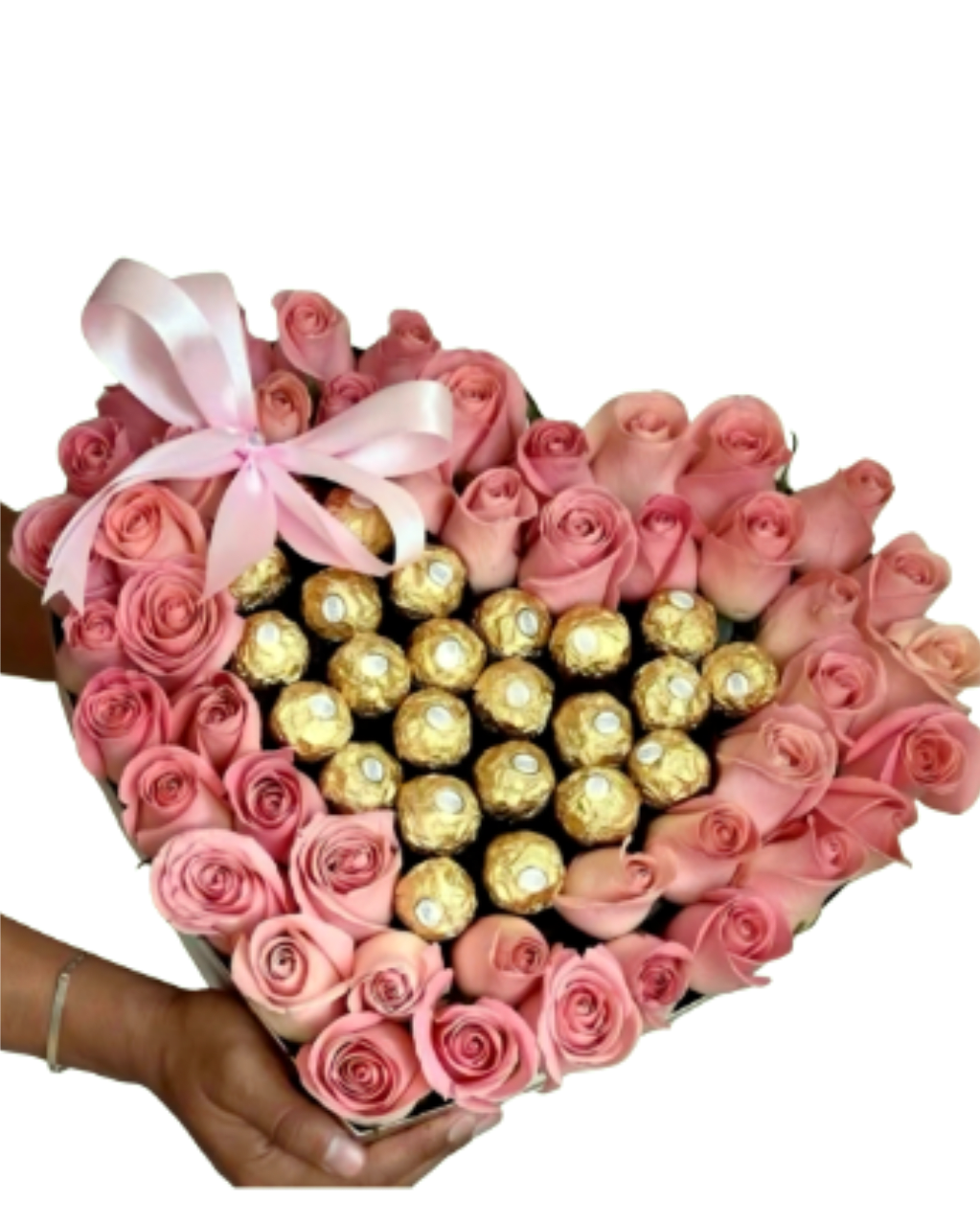 The Sweetheart Artisan Heart - A soulful curating where a sculptural frame of premium vintage-pink roses embraces a decadent heart of golden truffles. This handcrafted masterpiece fuses floral architecture with rich flavor, finished with a signature satin bow for a sovereign presence.