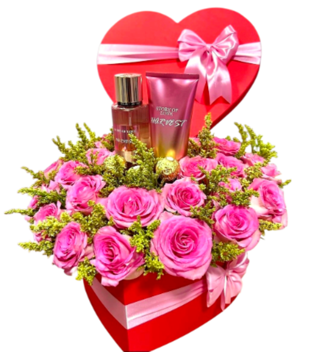 The Sweet Scent of Love Heart Box - A sensory masterpiece for Mom. This stunning red heart-shaped box features a plush bed of premium pink roses, paired with an exclusive fragrance mist and body lotion set. Accented with golden Ferrero Rocher chocolates, it's a complete luxury experience of art, fragrance, and sweetness.