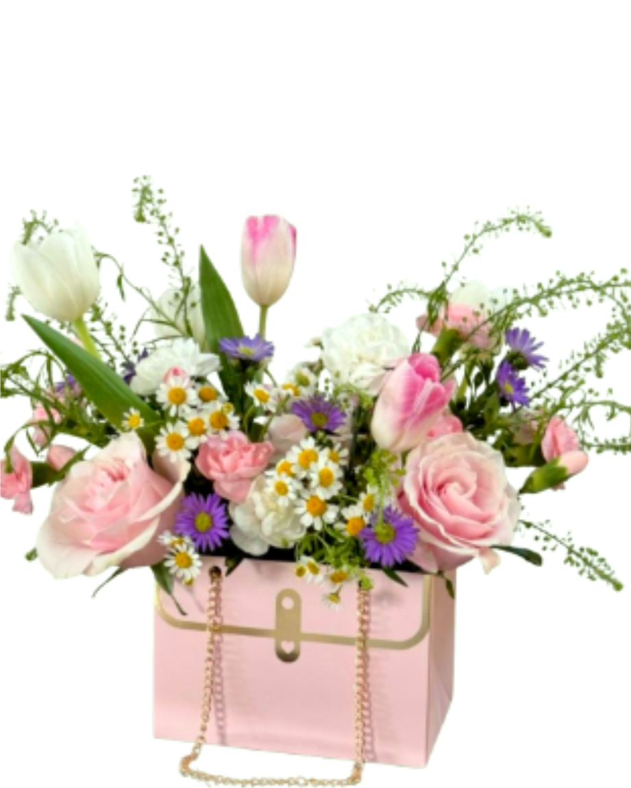 The Blush tElegance Purse Arrangemen  - Pure charm in a box. This lovely pink designer-style purse is filled with soft pink roses, elegant tulips, and cheerful daisies. A graceful and sophisticated gift from our Mother's Day collection that brings a touch of spring to her day. Includes free local delivery.