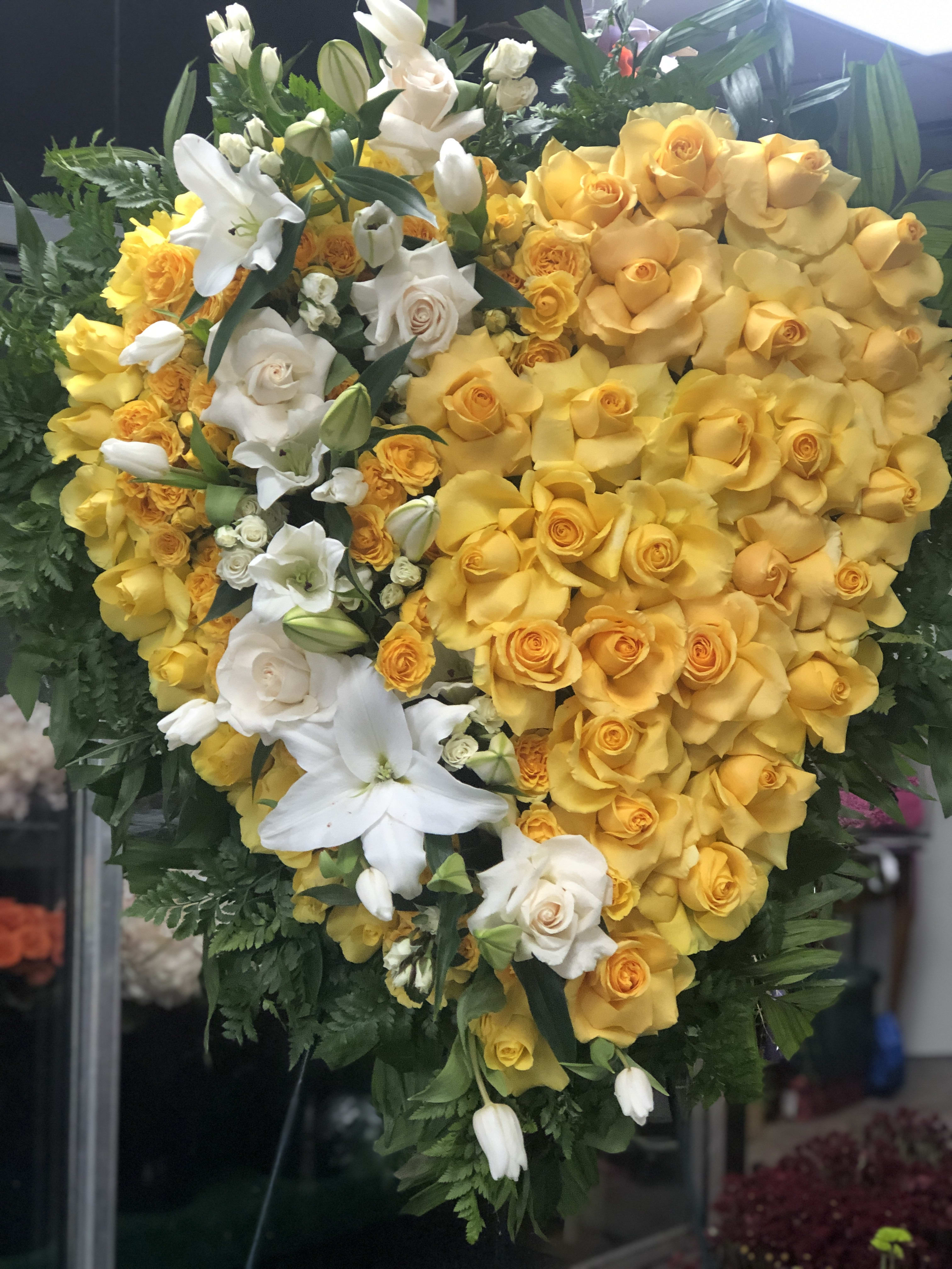 Heart-shaped bouquet of yellow and white roses with lilies
