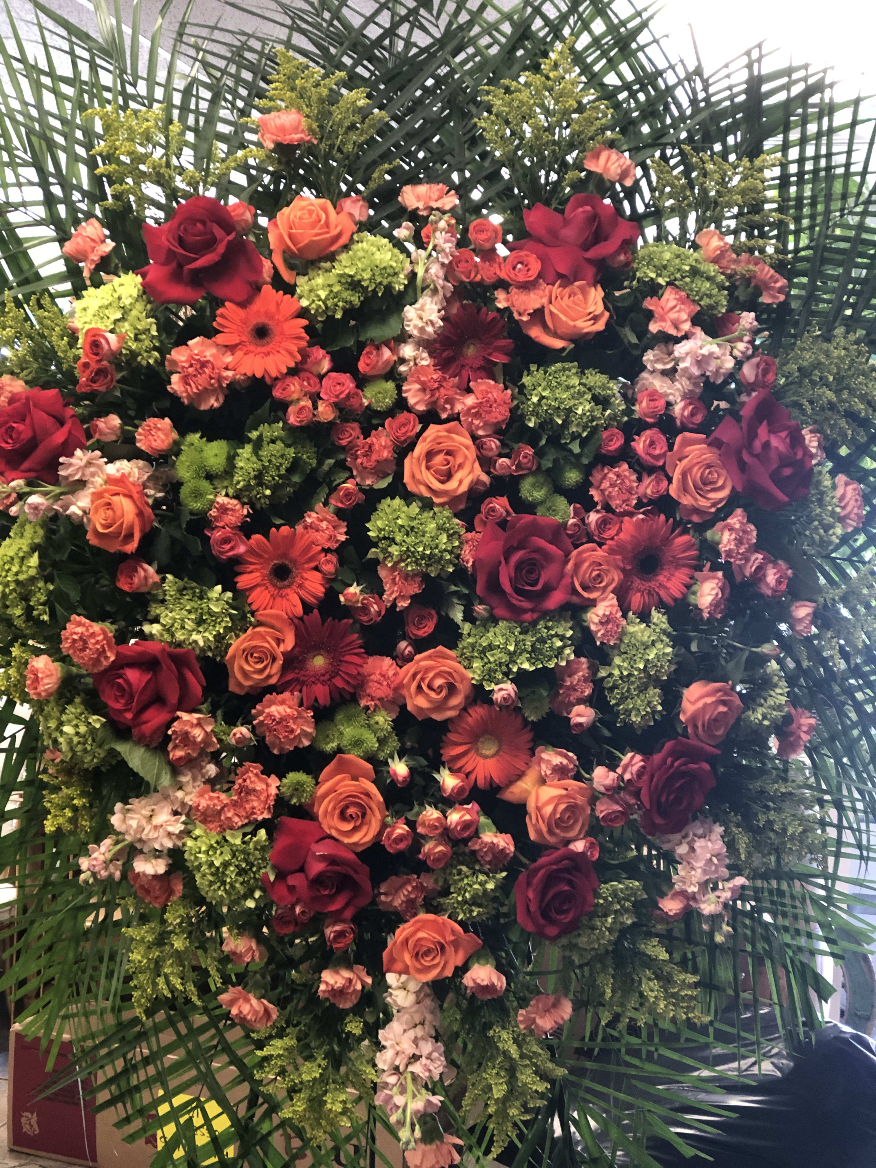 Heart-shaped floral arrangement with roses and gerbera daisies