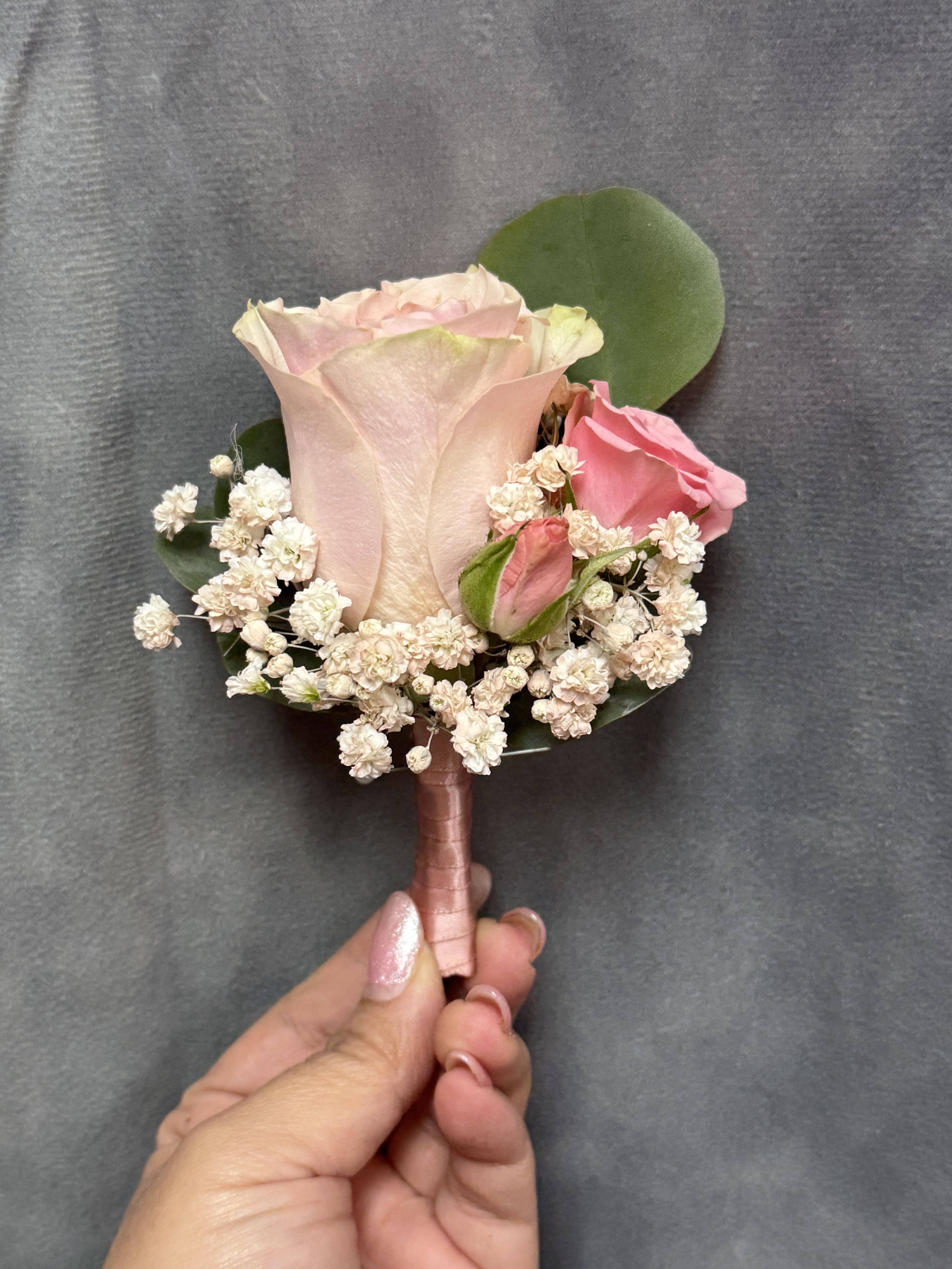Mix pink rose boutonnière  - Pink rose and spray roses with fillers and soft green leaves, wrapped in pink ribbon
