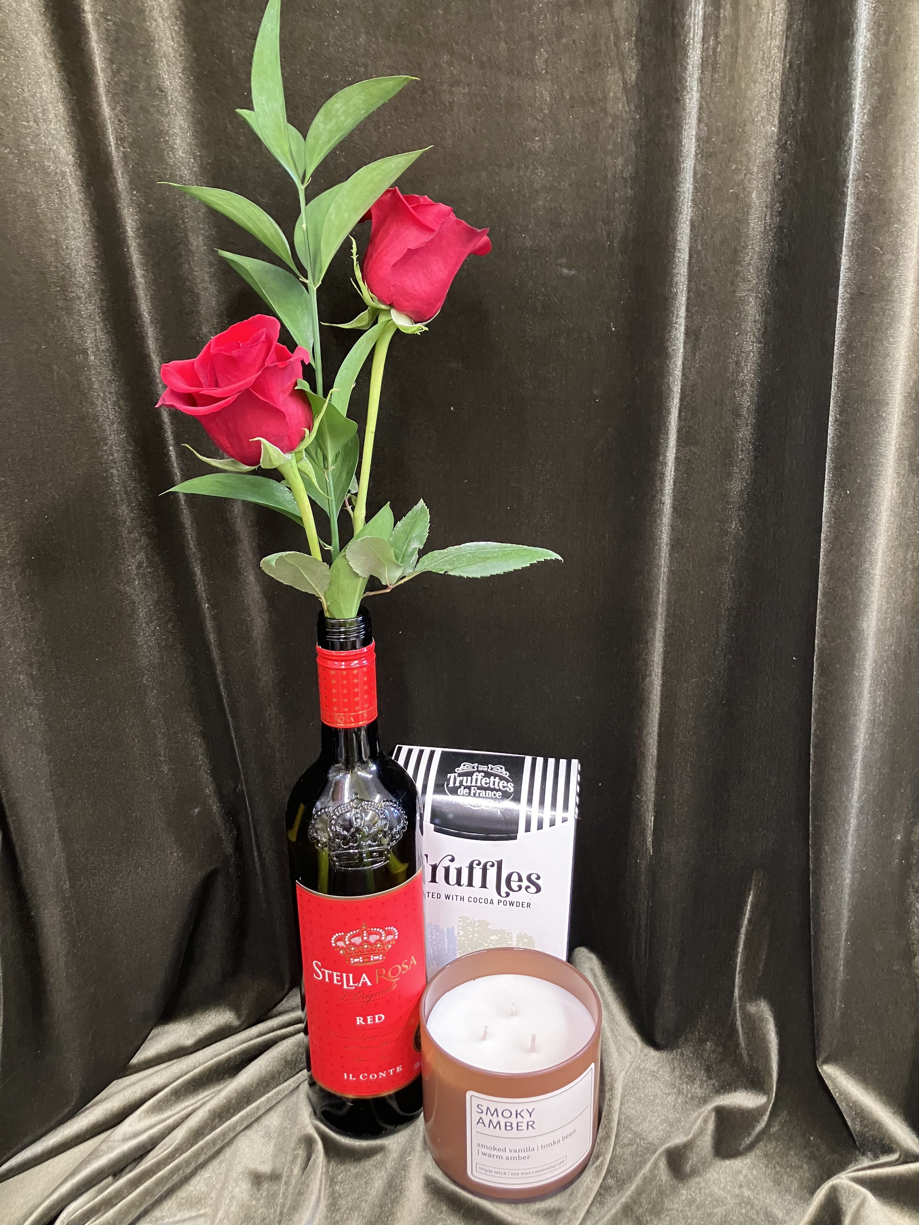 Wine Bottle Rose Gift - Walla Walla is known as wine valley and you can send a bit of Walla Walla with this long lasting long stem rose bud vase, arranged in a wine bottle. Petal Me Home Flowers re-uses glass and other containers to reduce waste, and we think this is a perfect idea to conserve the earths resources and make something beautiful!! Paired with a beautiful candle and chocolate this makes a wonderful gift.   