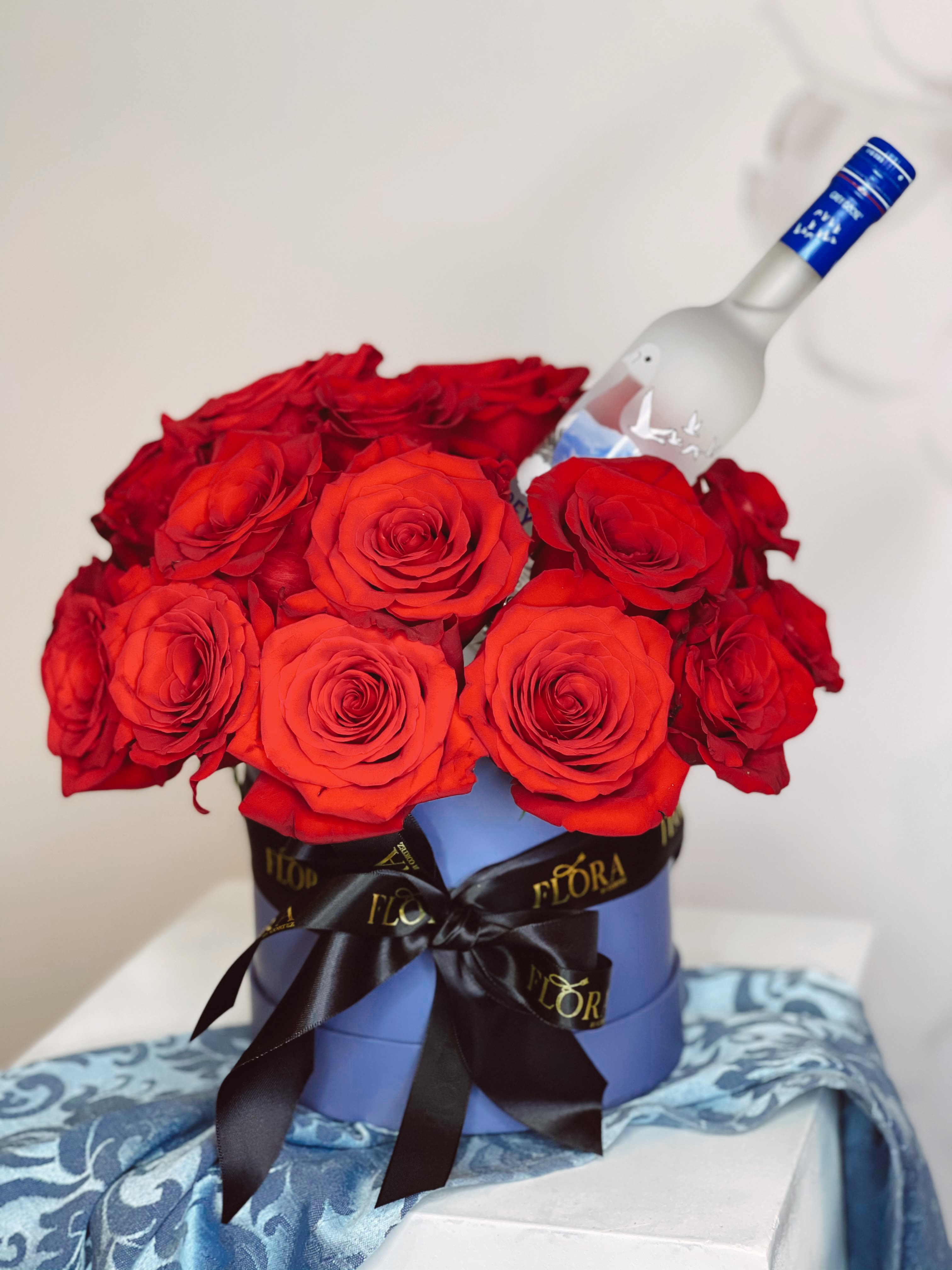 THE ICON - Make a bold statement with 70 red roses, a small Grey Goose vodka, and a heart-shaped box of Ferrero Rocher chocolates. The ultimate gift set for celebrating love, special occasions, or expressing admiration. Order this luxurious arrangement today!