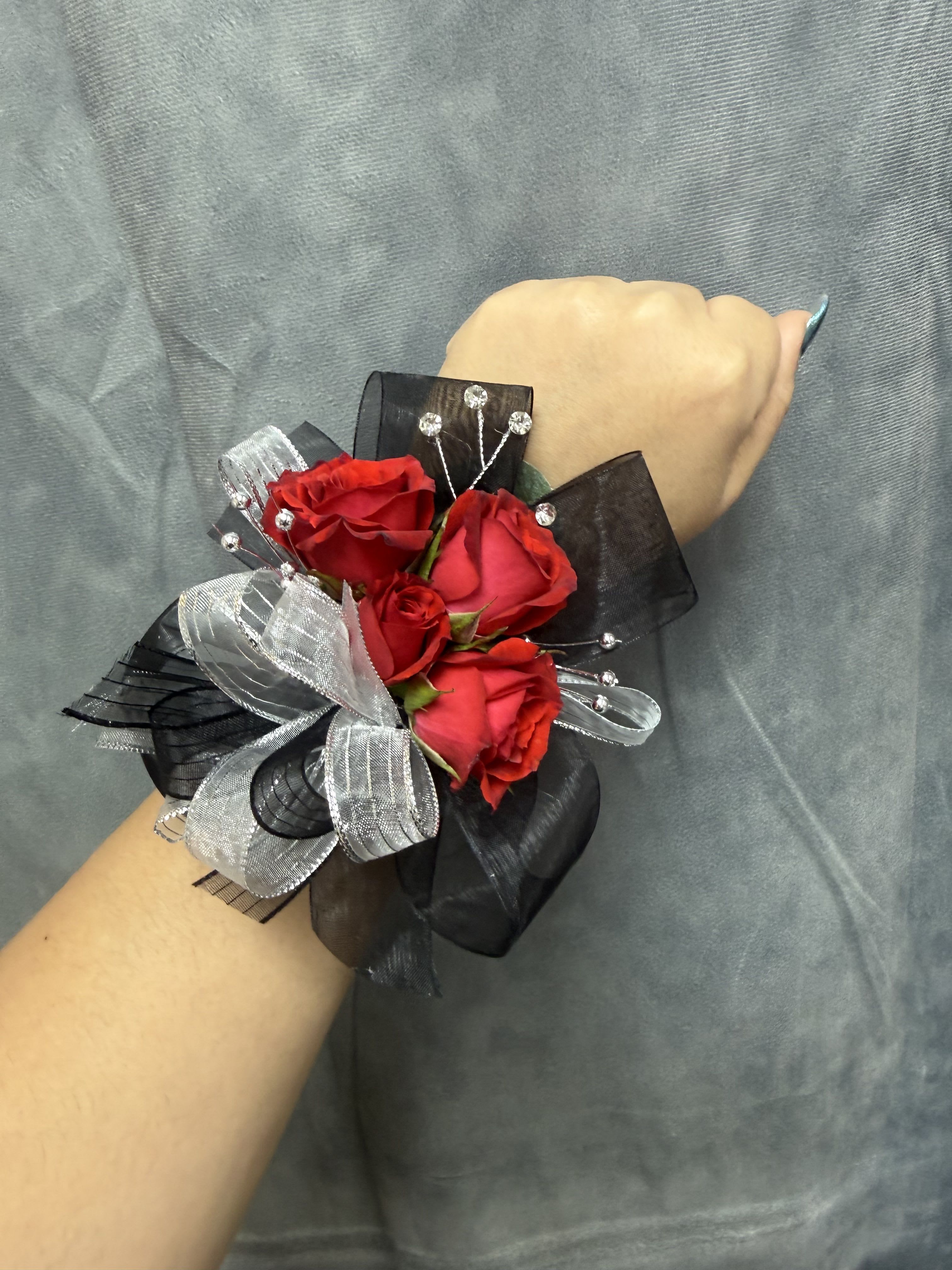 Red spray roses black silver corsage - Red spray roses with black and silver ribbon and bead accents on an pearl wristband-elegant for rom The corsage can be customized upon request 