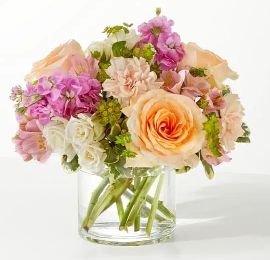 Pink and peach mixed bouquet in a clear glass vase