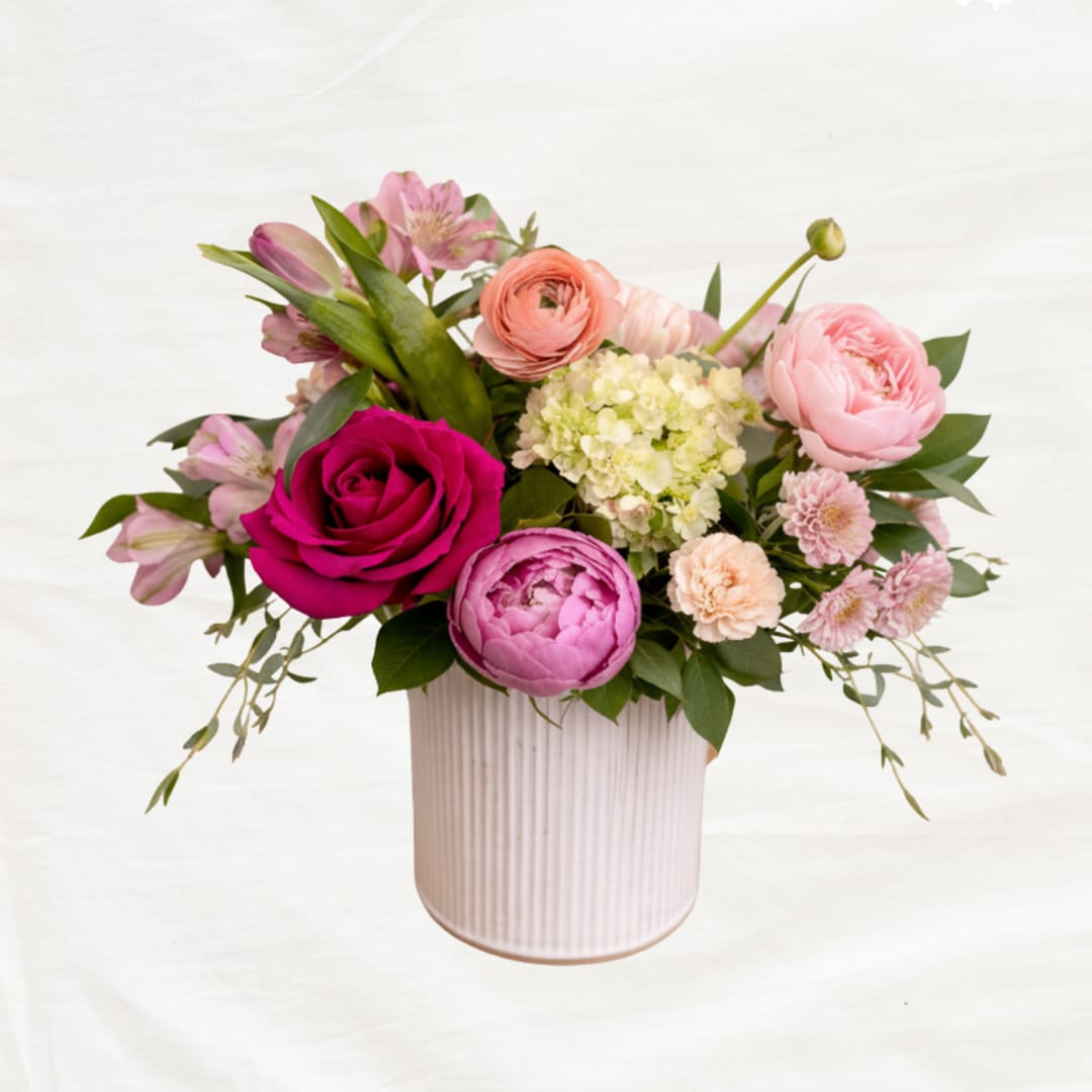 Mother's Garden - A full, garden-style arrangement in a 5.5” rustic tin, featuring a curated mix of seasonal blooms, soft textures, and natural greenery. Designed with movement and a slightly untamed feel—like a handful of flowers gathered straight from the garden.