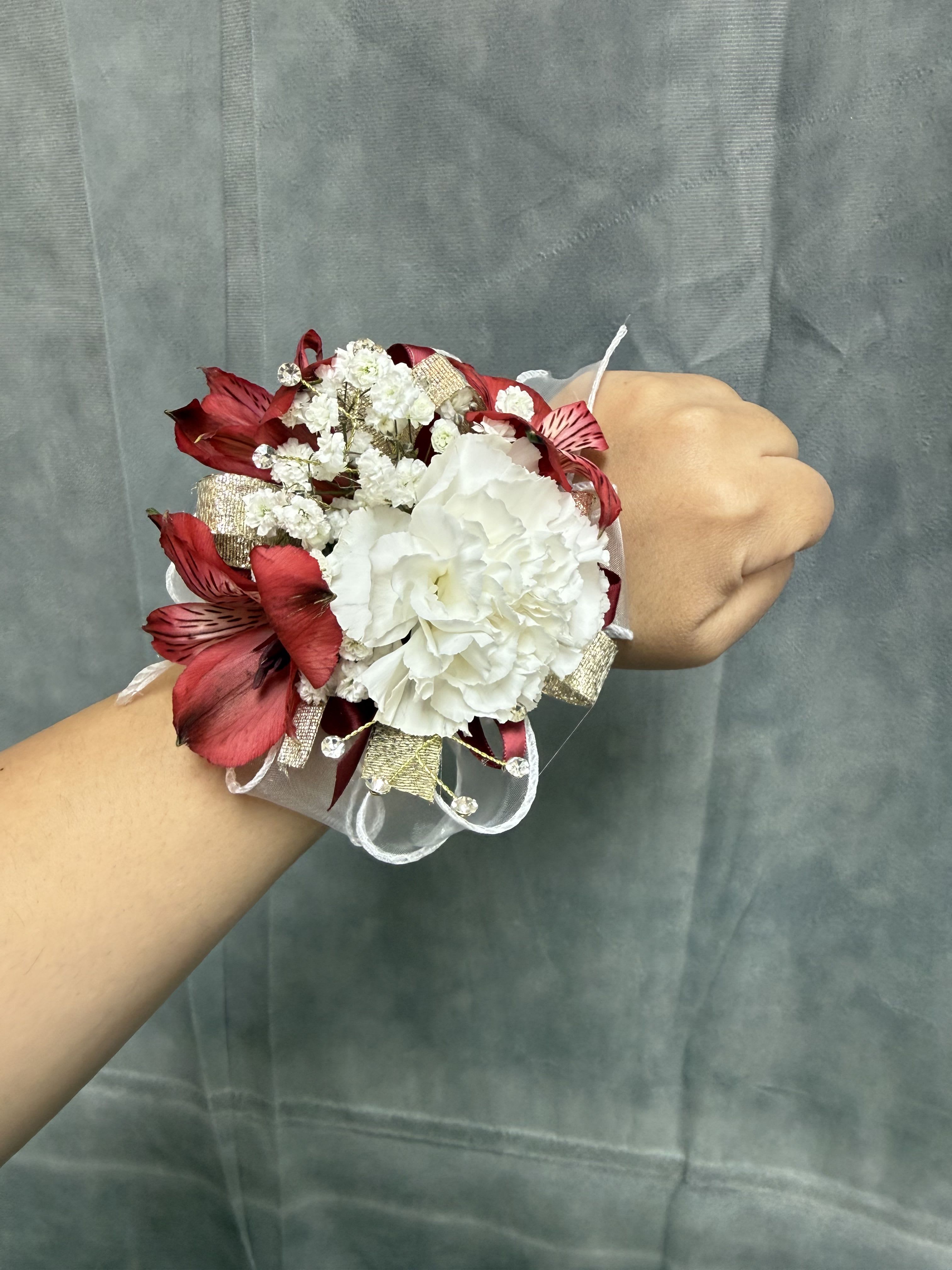 White carnation red gold corsage - White carnation wrist corsage with red alstroemeria accents, gold accents , rhinestones and ribbon with pearl wrist band elegant for prom