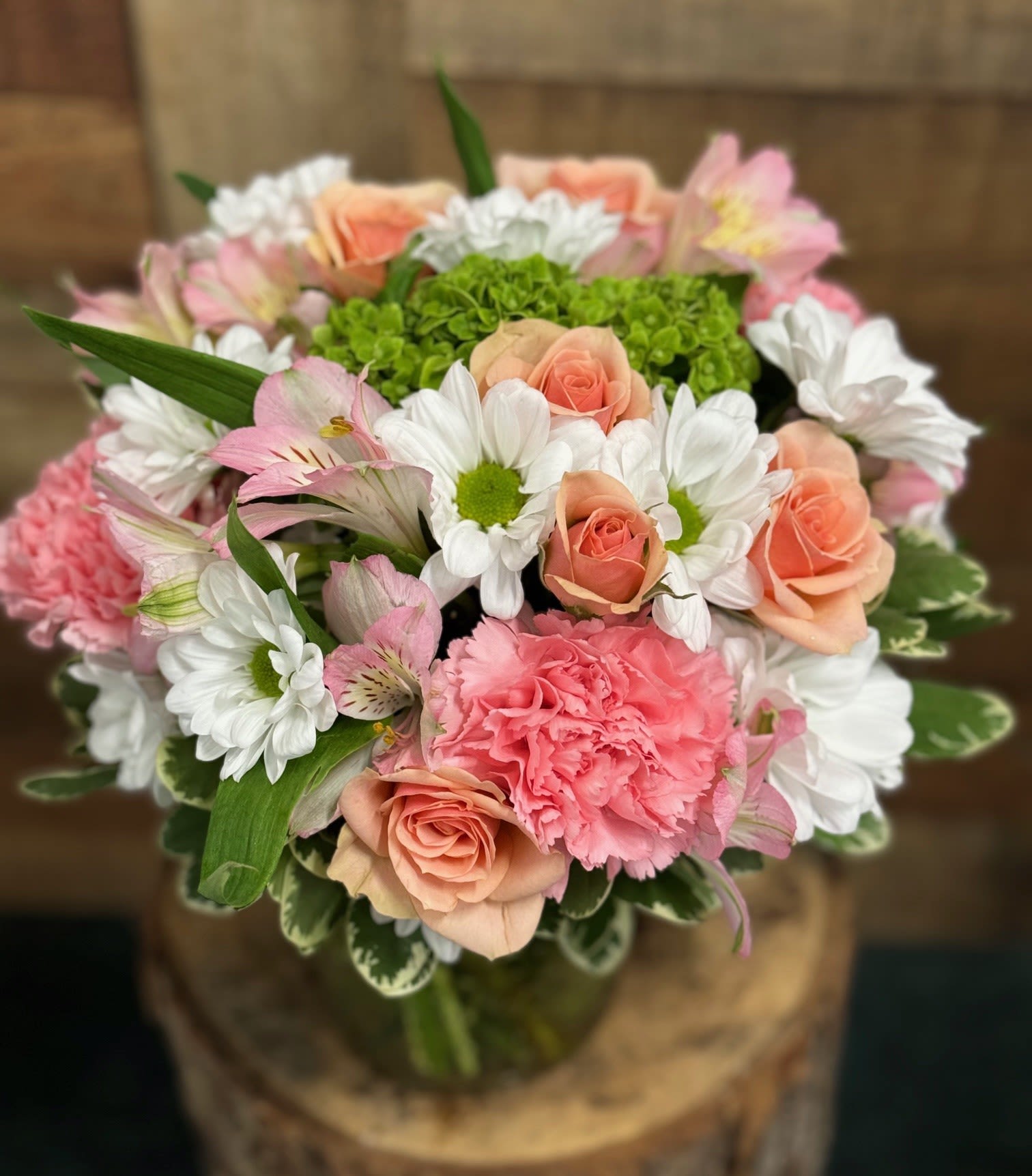 Bouquet of pink roses, carnations, and white daisies
