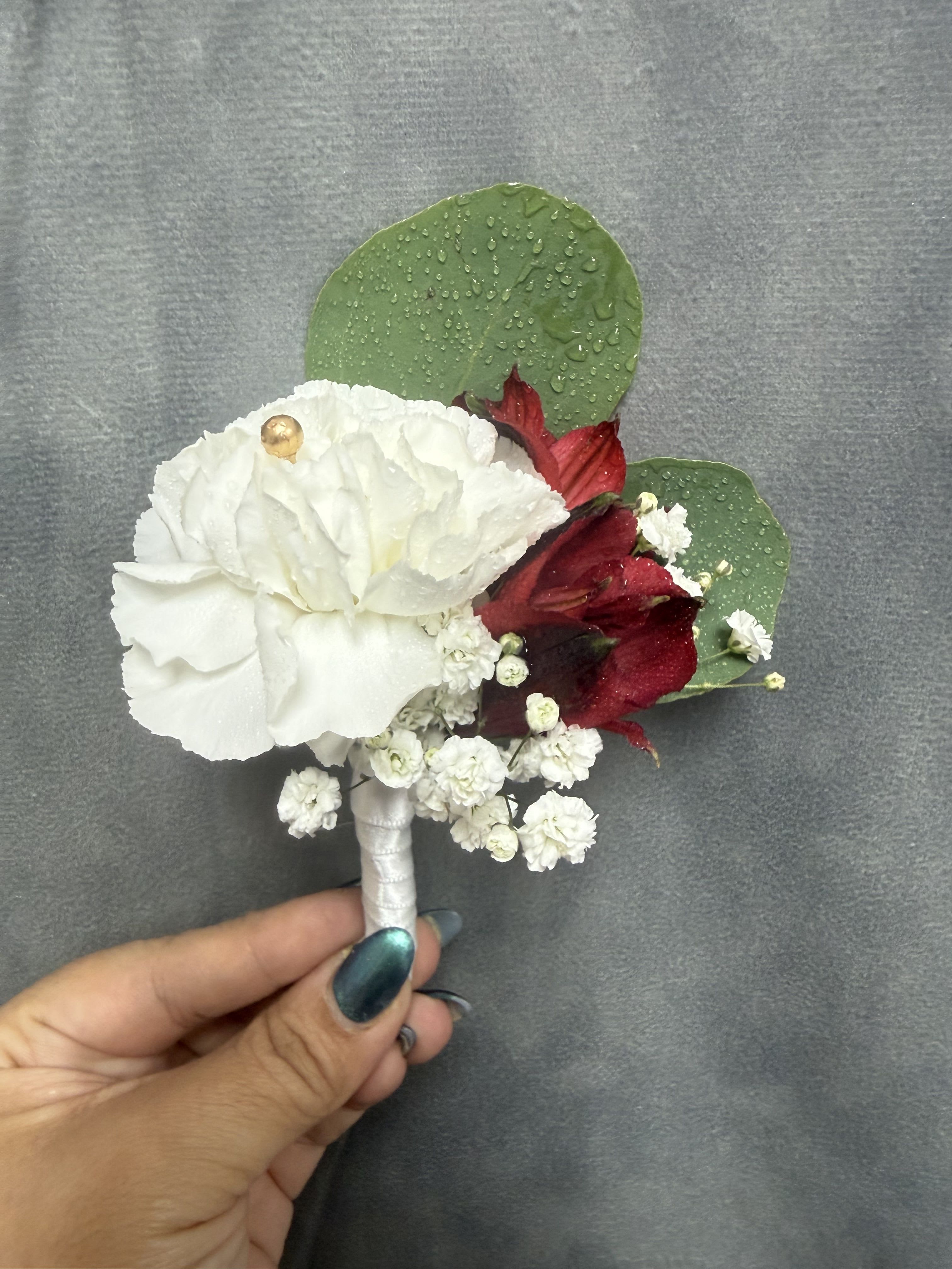 White carnation red alstroemeria boutonnière  - White carnation boutonnière with red alstroemeria , tiny white filler and green leaves, beautifully wrapped stem