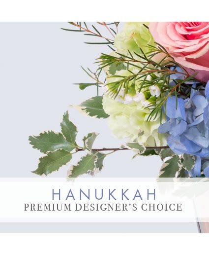 Hanukkah Beauty Premium Designer's Choice - Add some stunning, fresh flowers to the Festival of Lights! Our expert florists have designed a beautiful arrangement that is perfect for your loved ones this holiday. Send our Premium Designer’s Choice Hanukkah arrangement to someone you love!
