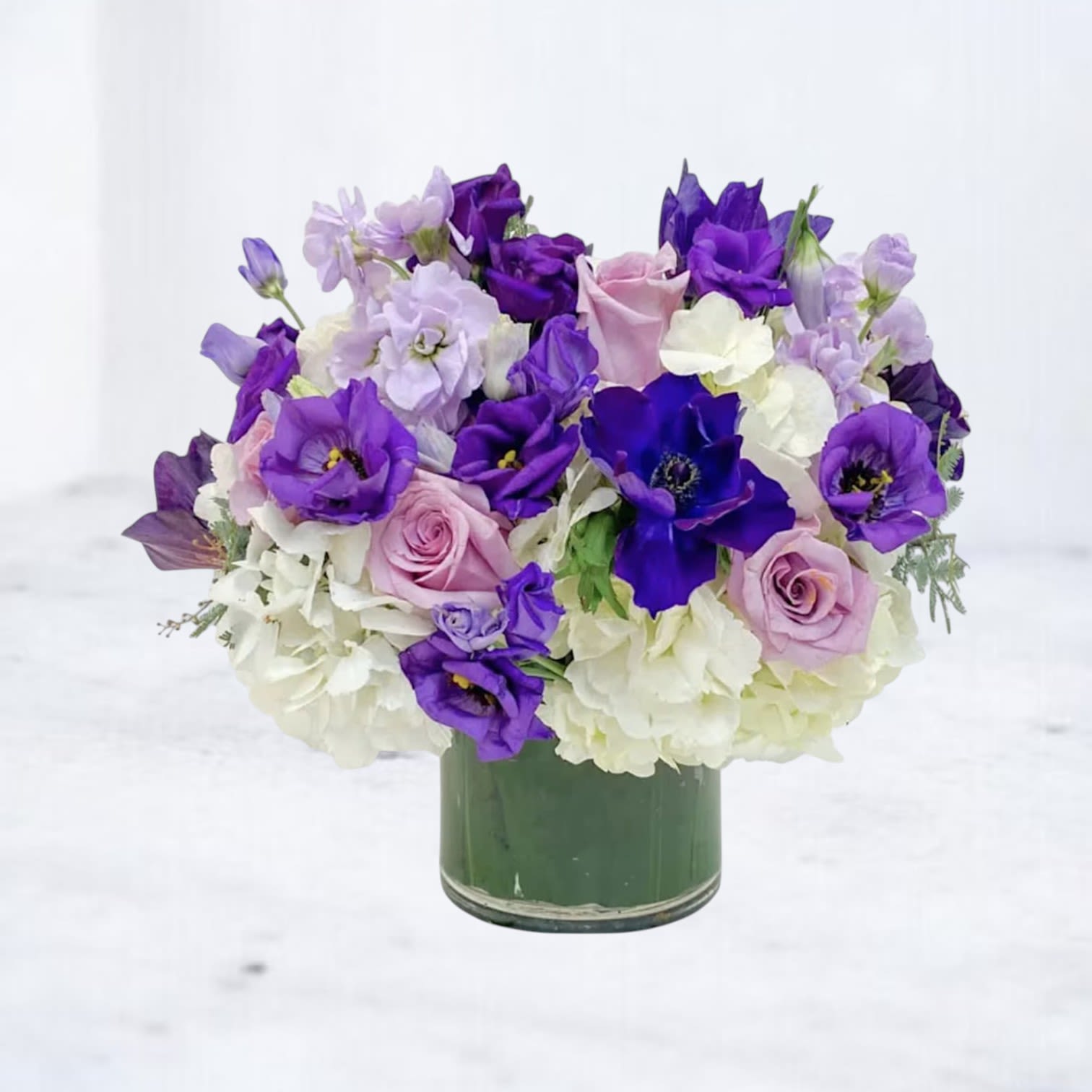Twilight Serenade Bouquet - The Twilight Serenade Bouquet is a symphony of purples and lavenders, featuring velvety lisianthus, delicate roses, and soft hydrangeas. This lush arrangement is elegantly designed to evoke the calming beauty of dusk, with each bloom adding depth and texture. Perfect for expressing admiration, celebrating special moments, or simply brightening a loved one's day with its serene charm.