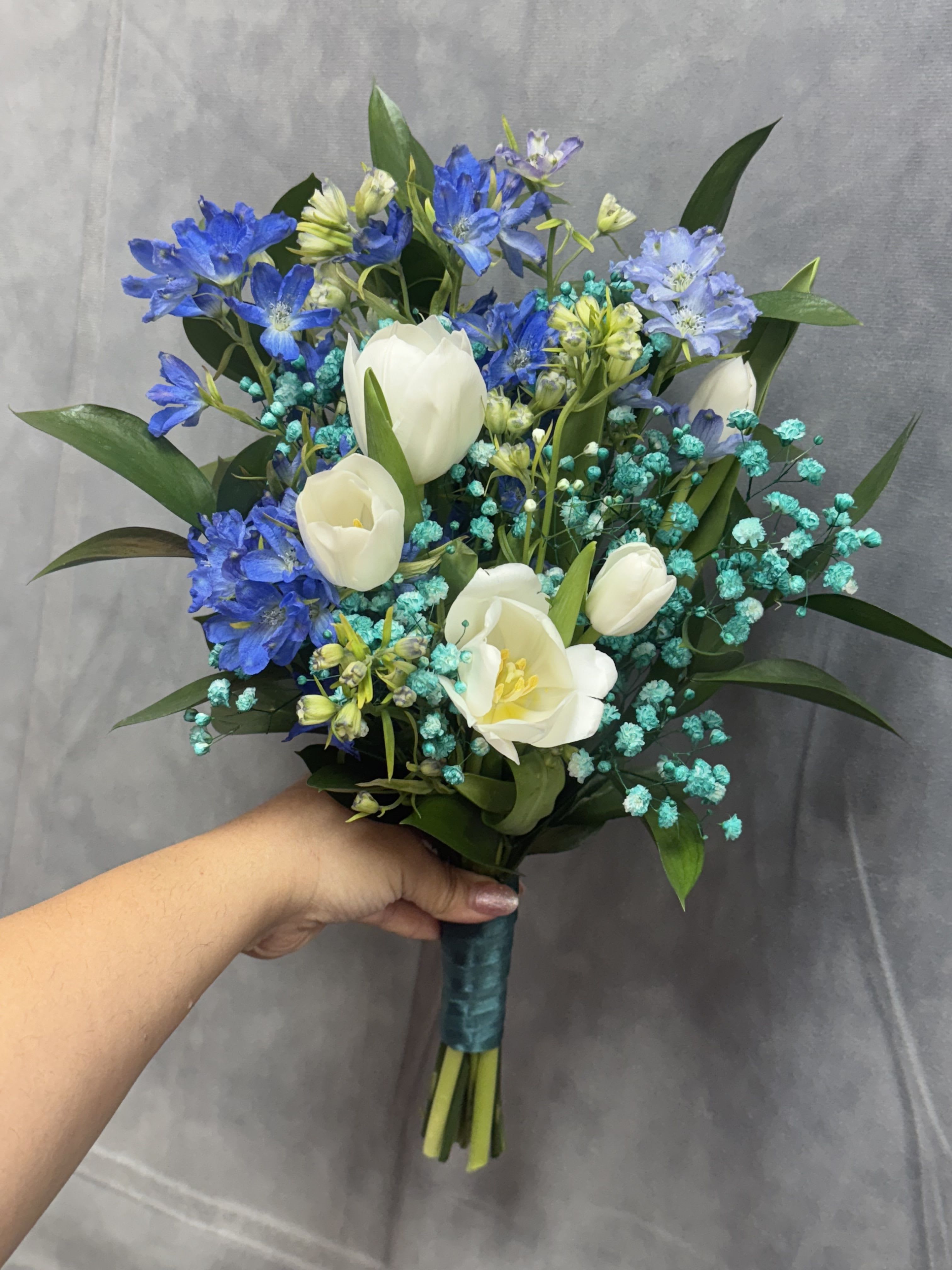Aqua Royal Prom Bouquet  - White tulips with blue delphinium-like blooms and teal aqua filler, hand-tied with teal ribbon perfect for prom .