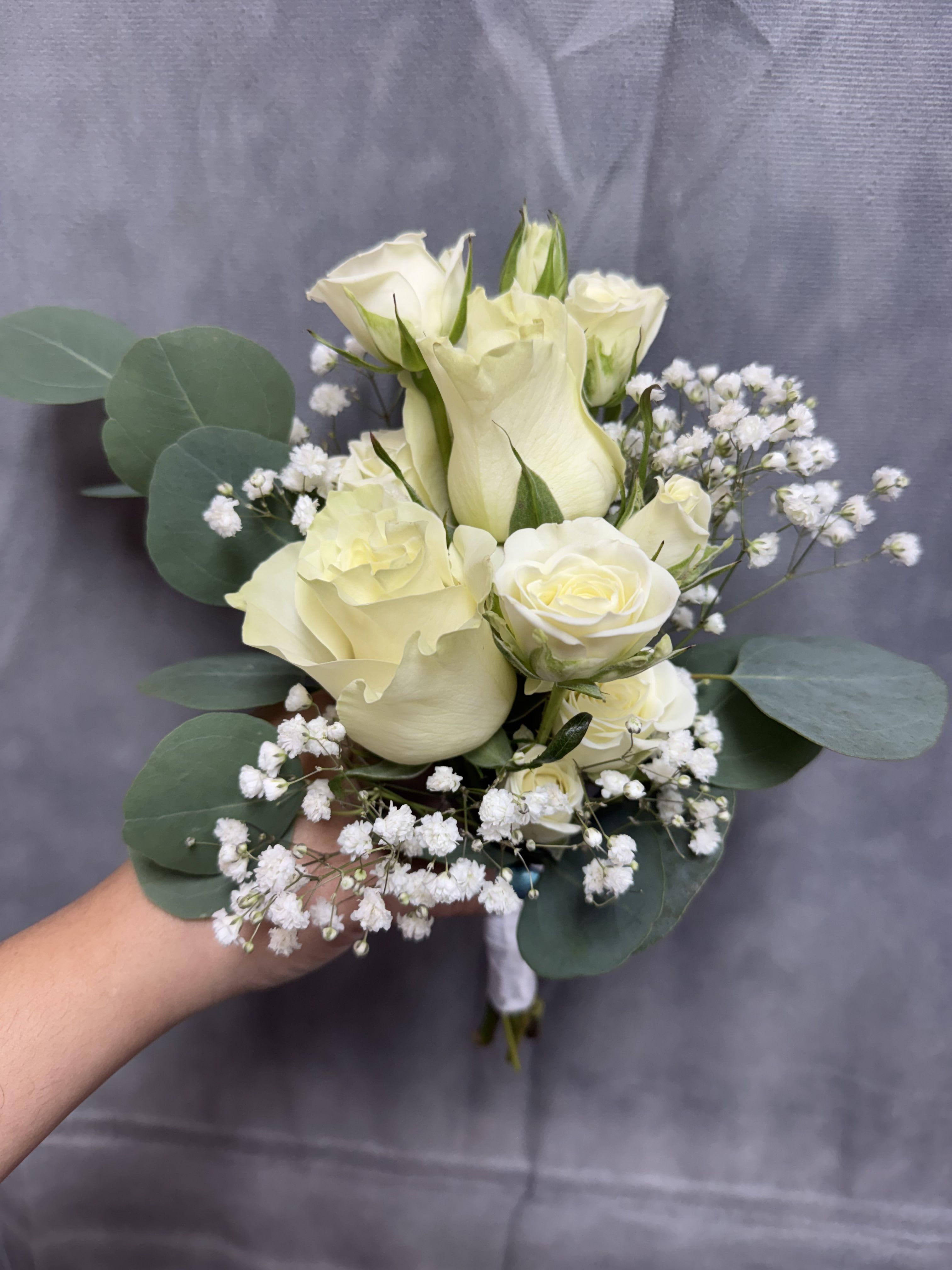 White rose prom bouquet - Creamy white roses, spray roses  with baby's breath and eucalyptus; a compact, romantic bouquet in soft whites 