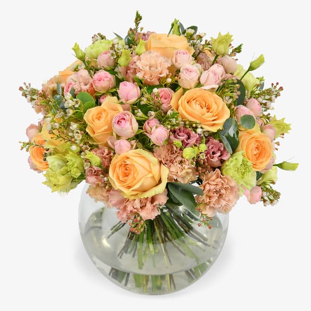 A wonderful peach bouquet - A wonderful mix of peach roses and delicate pink spray roses. The soft pastel shades are combined with some of our favourite long lasting flowers to create beautiful gift that will bring you joy over several days. Finished with eucalyptus and waxflower to give a soft and sweet aroma, this is arrangement is suitable for any occasion.