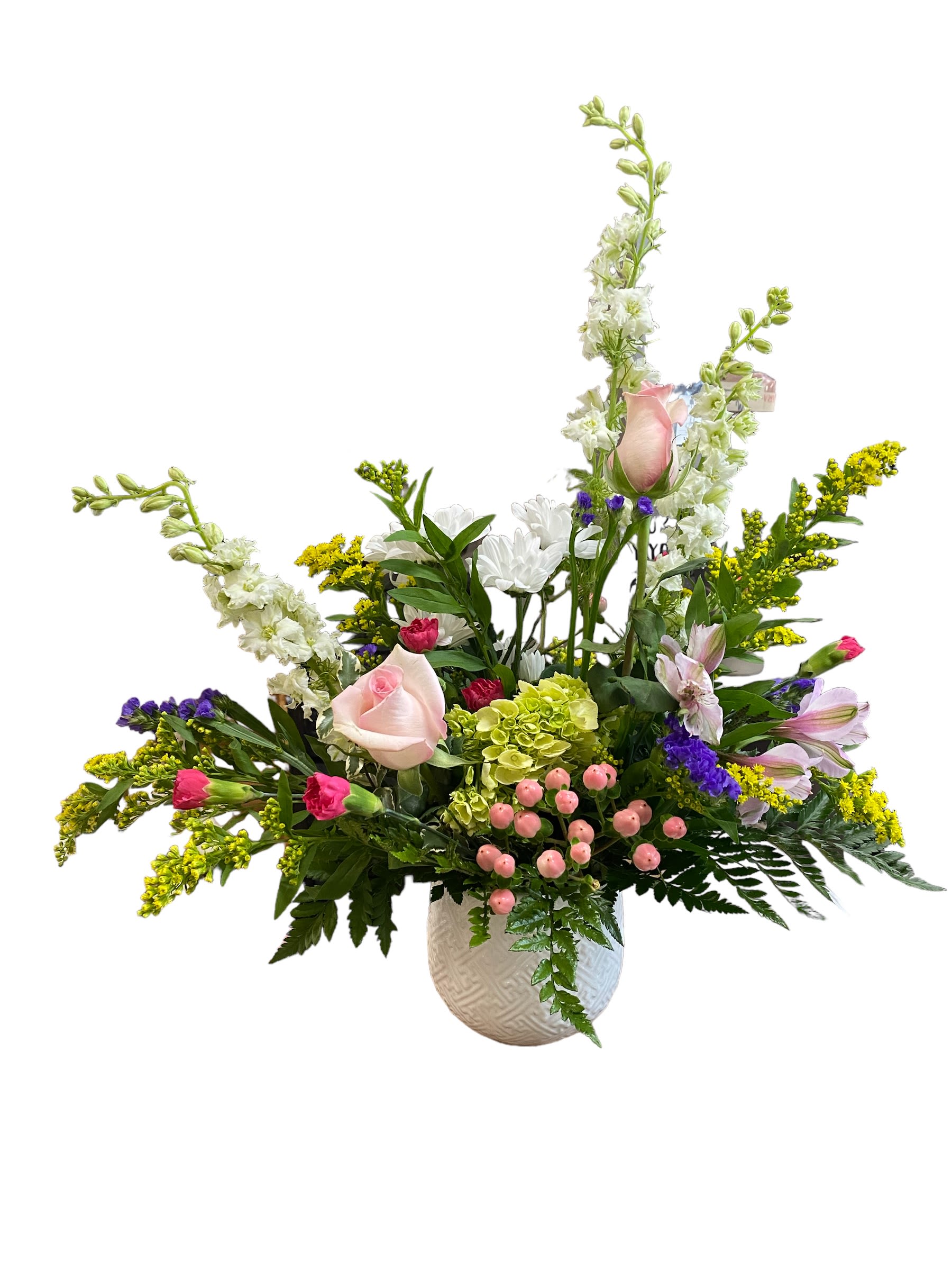 Mixed floral arrangement in a white textured vase with pink roses and white blooms