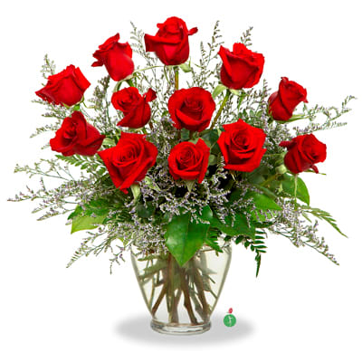 Red roses arranged in a clear glass vase