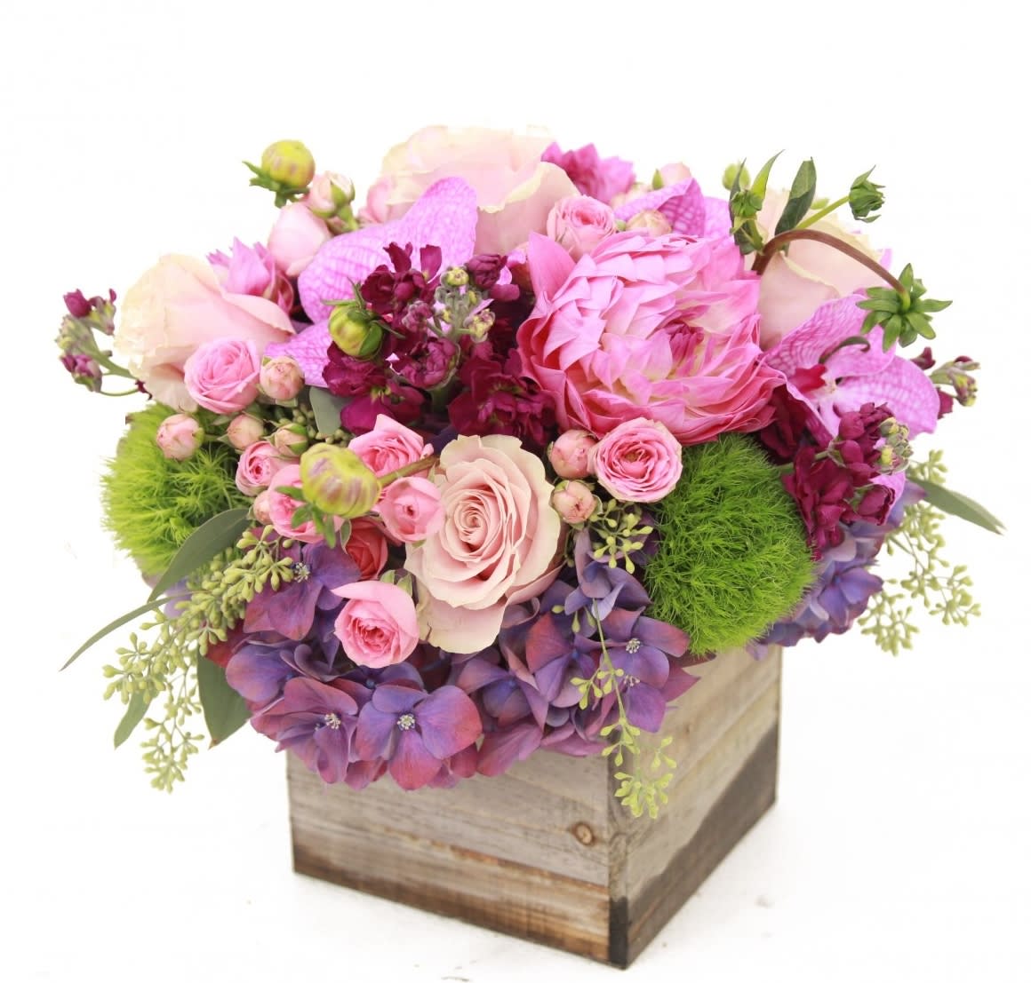 Amelie - This bouquet is a wondrous love sonnet in floral form.Flowers in hues of wooden box arranangement filled with purple hydrangea, pink roses, candy pink spray roses,  , green dianthus and fuschia stock