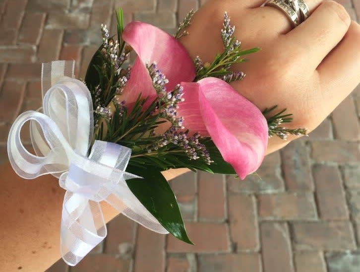 Pink calla lily wrist corsage with white ribbon