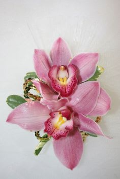 Pink orchid corsage with ribbon and small green accents