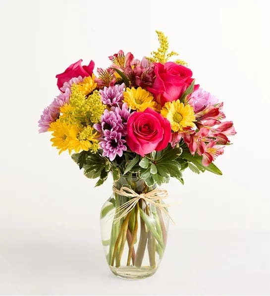 Fields of Europe Spring - This seasonal spring arrangement features a bright and cheerful mix of blooms such as hot pink roses and yellow Asiatic lilies guaranteed to bring a little spring sunshine into any love one's home. 