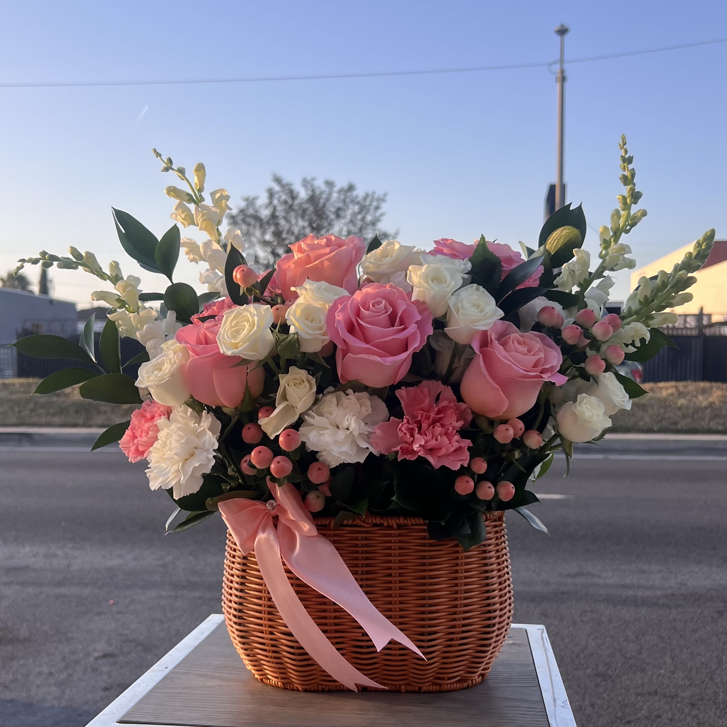 The Blooming Love Basket With Pink Flowers - A soft and elegant mix of pink roses and delicate blooms, perfect for a sweet and unforgettable surprise 