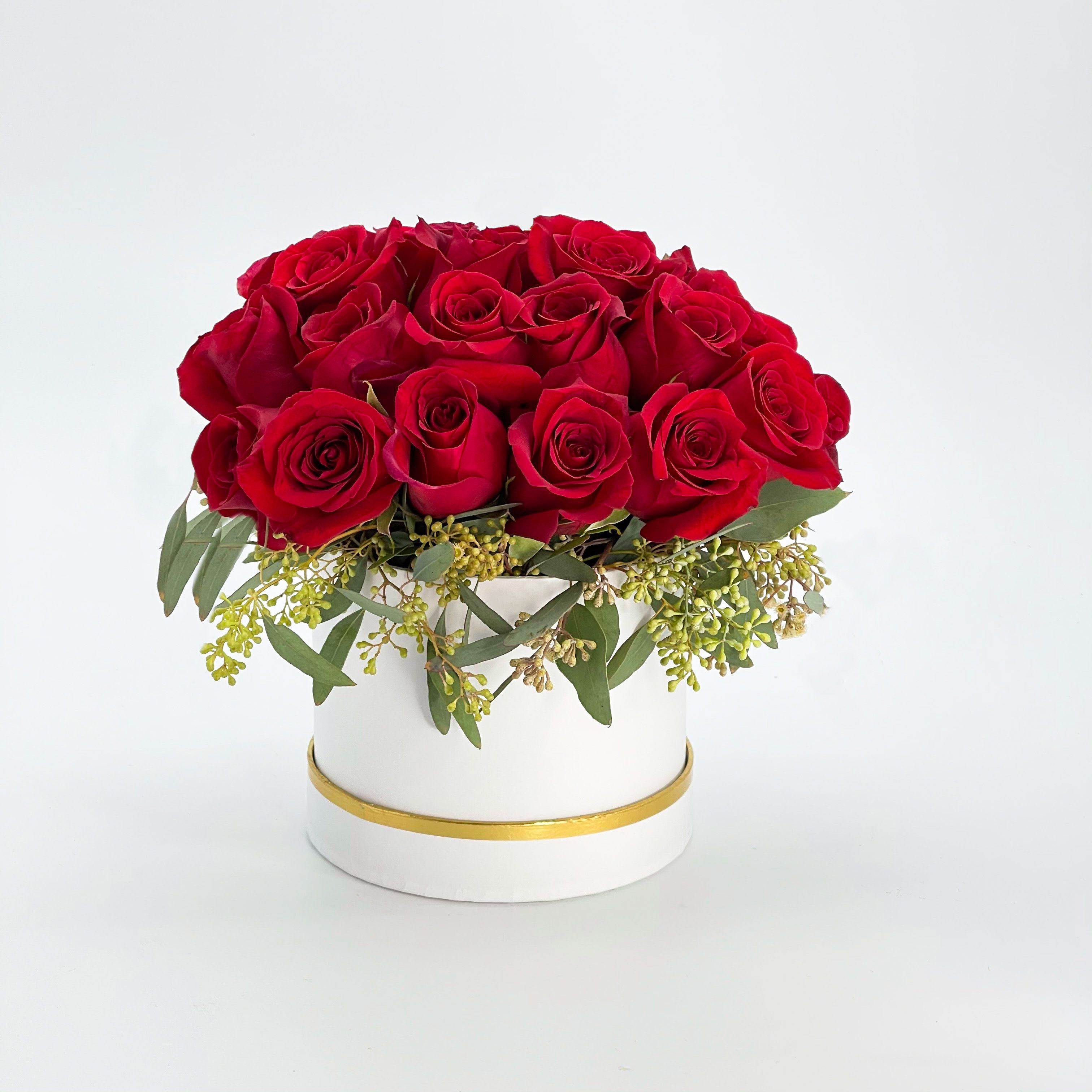 Elegant Red Roses - A refined presentation of vibrant red roses in a stylish container, designed to impress and celebrate love, anniversaries, or special occasions.