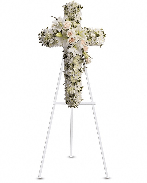 Pure Serenity Cross - A refined and elegant cross arrangement crafted with soft white blooms, including delicate roses, chrysanthemums, and graceful lilies. Accented with subtle greenery, this design embodies peace, purity, and everlasting love—offering a serene and heartfelt tribute to honor and remember a cherished life.