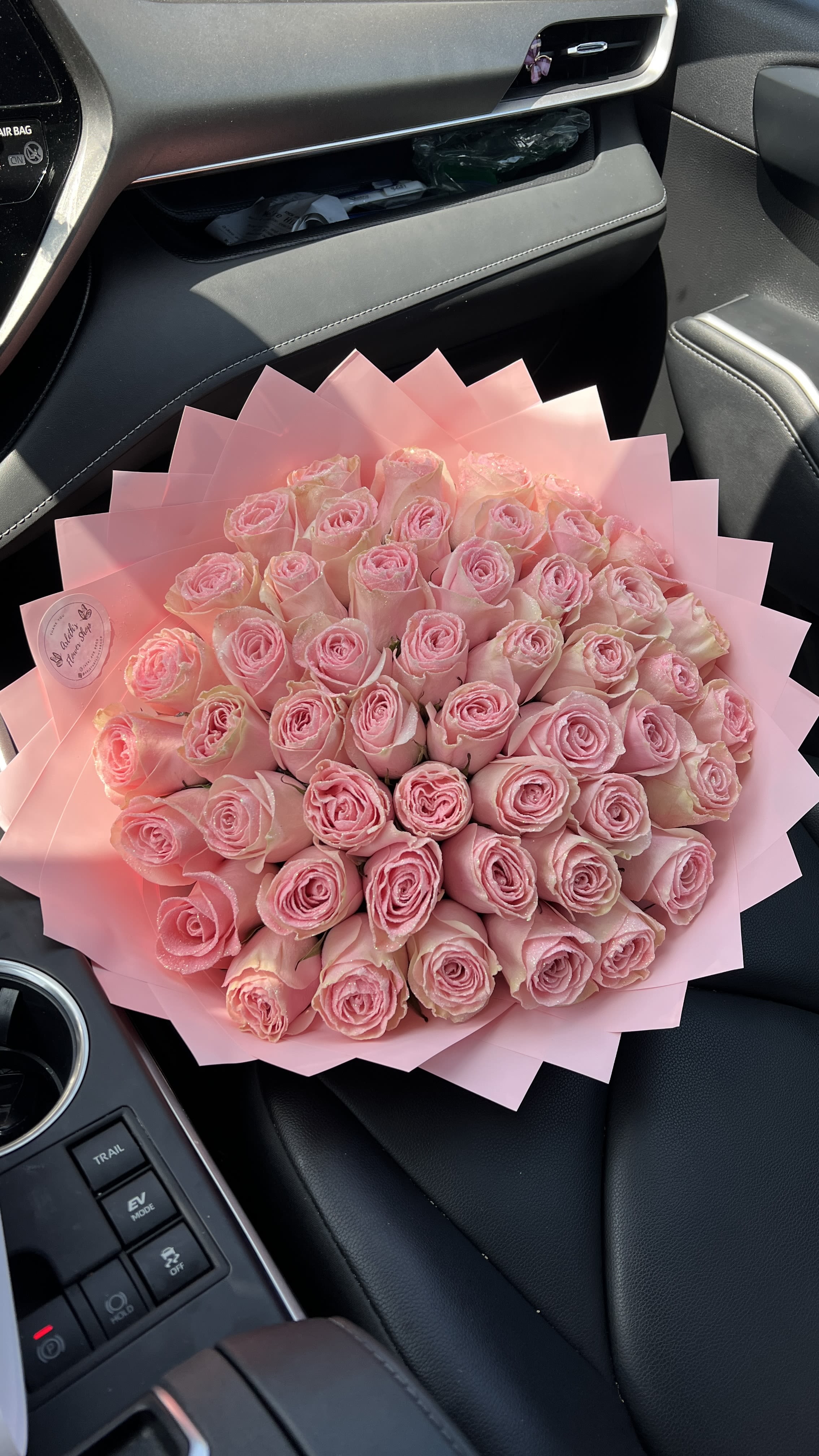Large bouquet of pink roses wrapped in pink paper