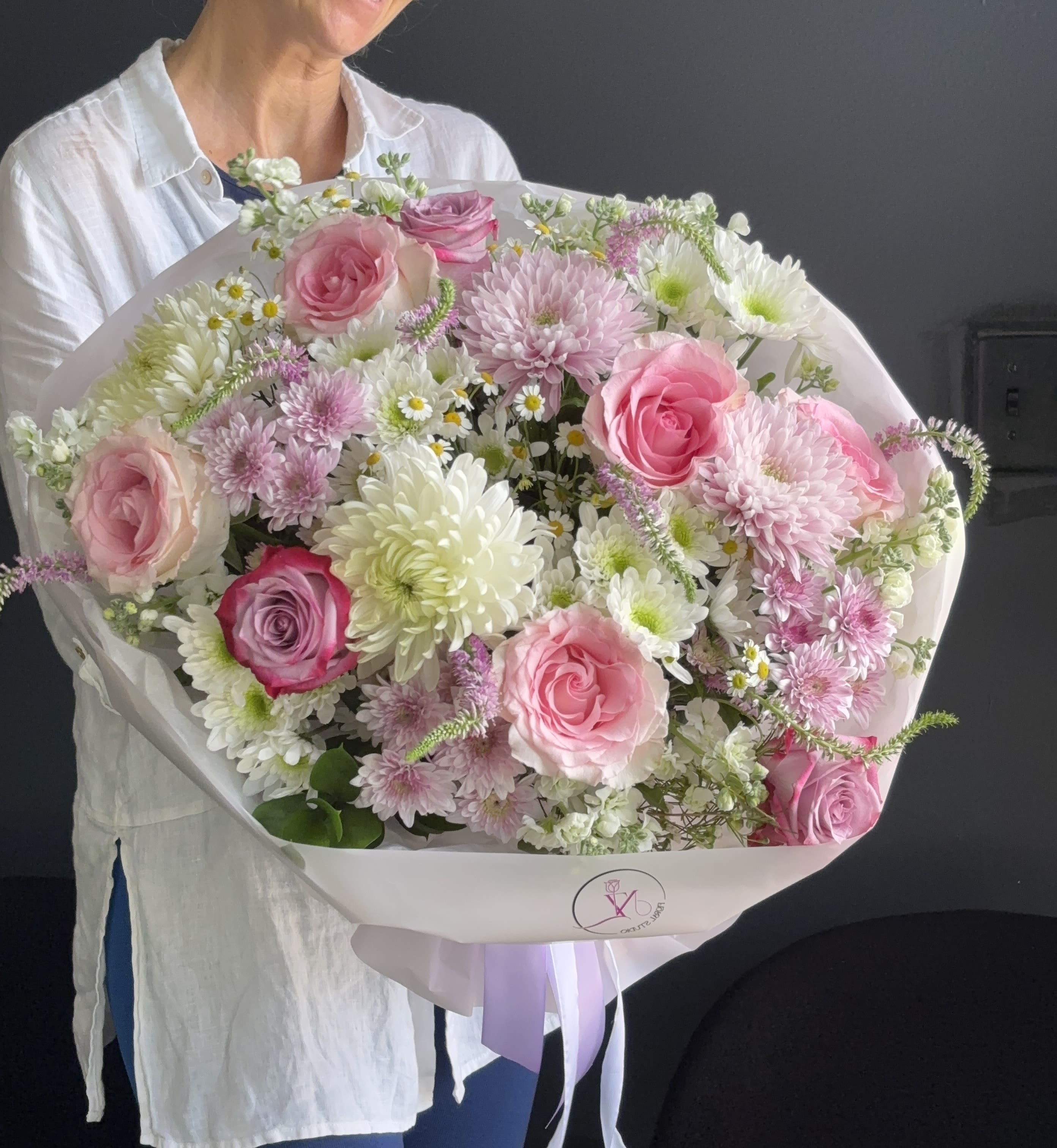 Blush Garden Elegance - Blush Garden Elegance is a refined, garden-style bouquet designed to feel light, natural, and effortlessly beautiful. This arrangement combines soft pink roses, delicate spray blooms, airy chamomile accents, and lush white chrysanthemums to create a romantic and textured composition. The palette of blush pink, creamy white, and fresh green tones brings a sense of calm elegance and femininity. Its loose, organic structure gives the bouquet a modern European feel — perfect for birthdays, gentle celebrations, or simply to brighten someone’s day with beauty and softness. This bouquet is ideal for those who appreciate natural floral design, subtle luxury, and timeless charm. 