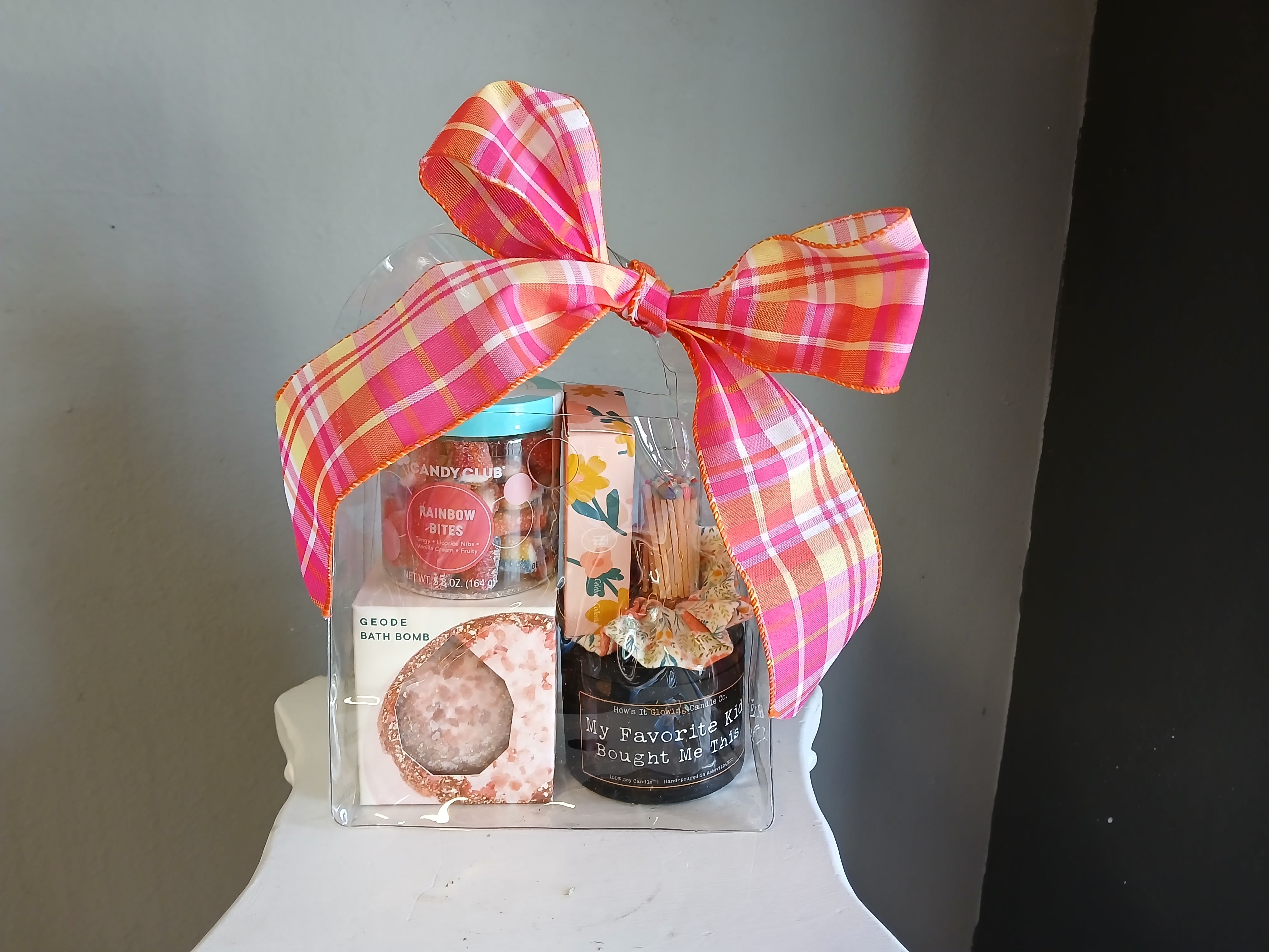 Mother's Day Gift Set - This gift basket is full of relaxing goodies. Includes one sweet-smelling candle, matches, a bath bomb, shower steamers, a scrunchy and rainbow-creme filled candles!