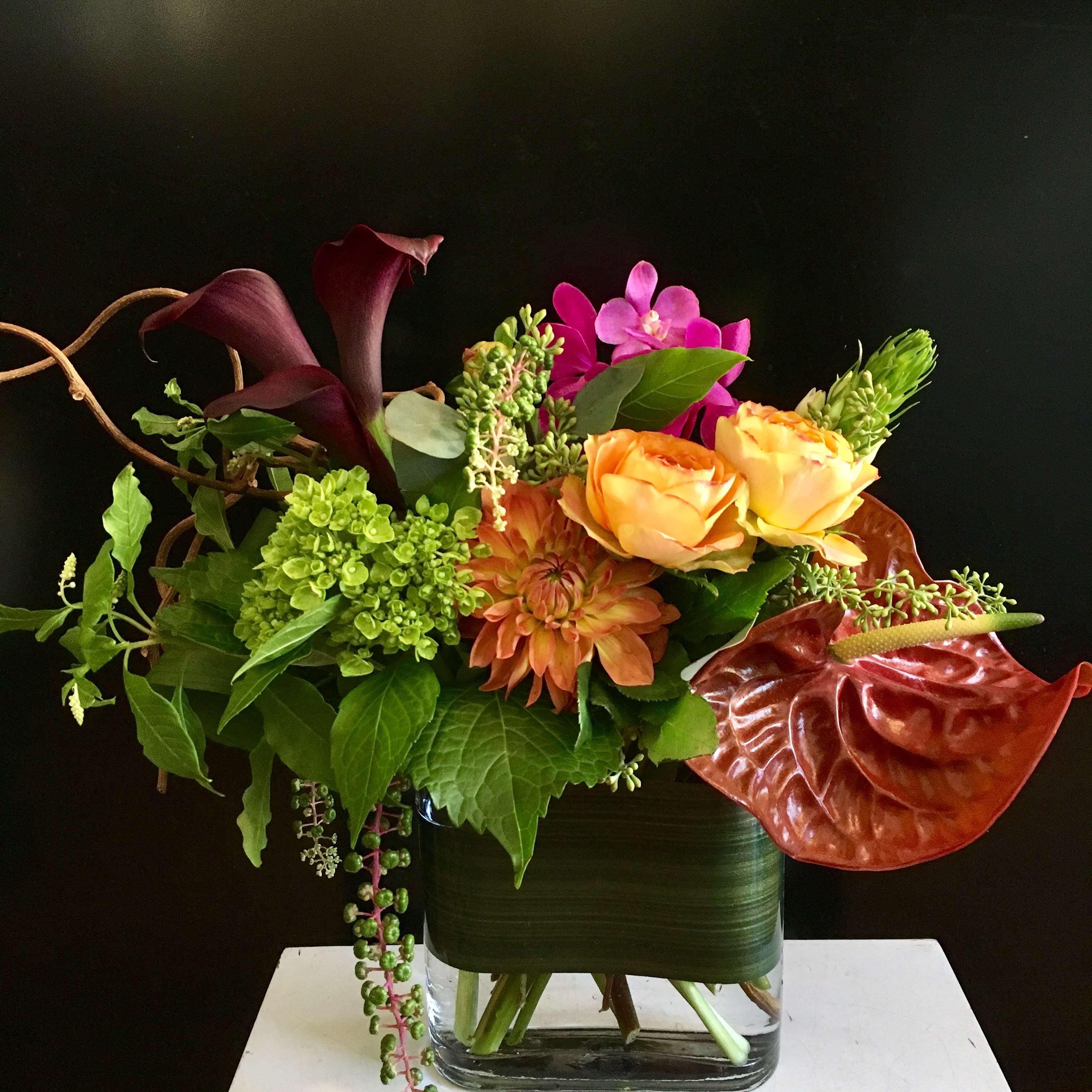 Kotobuki. (Long life.) - In Japanese Kotobuki means "long life" and Momo created this arrangement to celebrate a feeling of enduring positivity. Things got you down? A loved one in need? Kotobuki arrives just in time. Regal without being stuffy, comforting without being cloying, Kotobuki says there is something enduring even in the fragility of flowers. Kotobuki says "Cheers to a long life!"   May include Roses, Calla Lillies, Dahlia, Roses, Aranthia Hydrangea, Orchids and Kiwi vine.