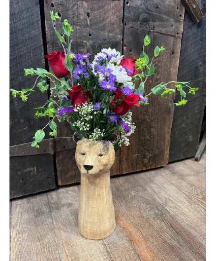 BEARY Sweet Arrangement Custom Design Arrangement - This BEARy sweet arrangement features Red roses, purple asters and fun greenery for Valentine's day but we are happy to put different flowers/colors in if you prefer - just make a note in your order or give us a call at the shop. Pottery Bear vase is about 16 inches tall