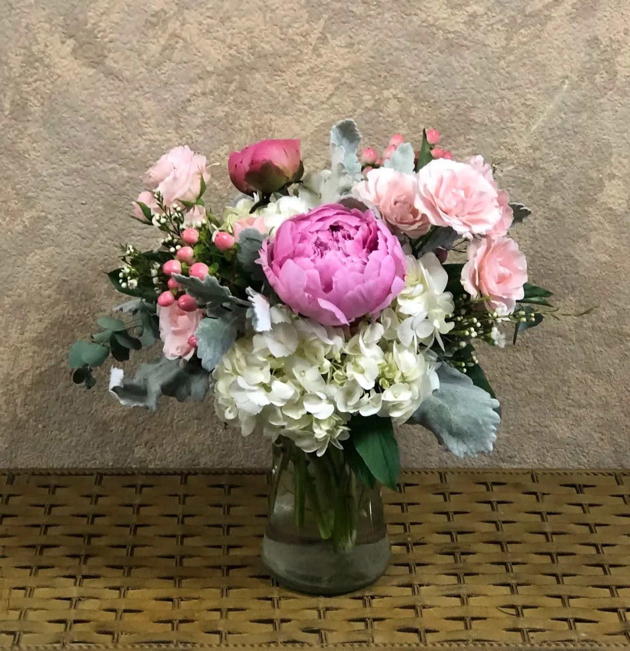 Pink and white flower arrangement in a glass vase